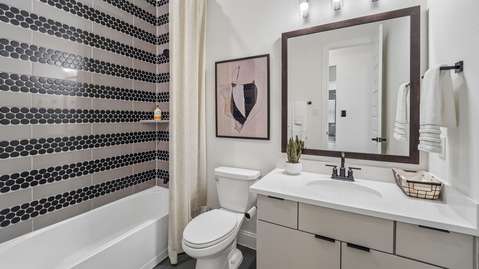Experience opulence with striking black hexagon tiles and sleek fixtures in The Woodlands Hills.