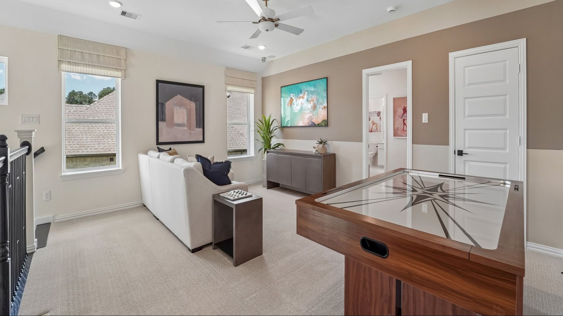 Luxurious open living area with chic black cabinetry, plush white seating, and ambient lighting in The Woodlands Hills.