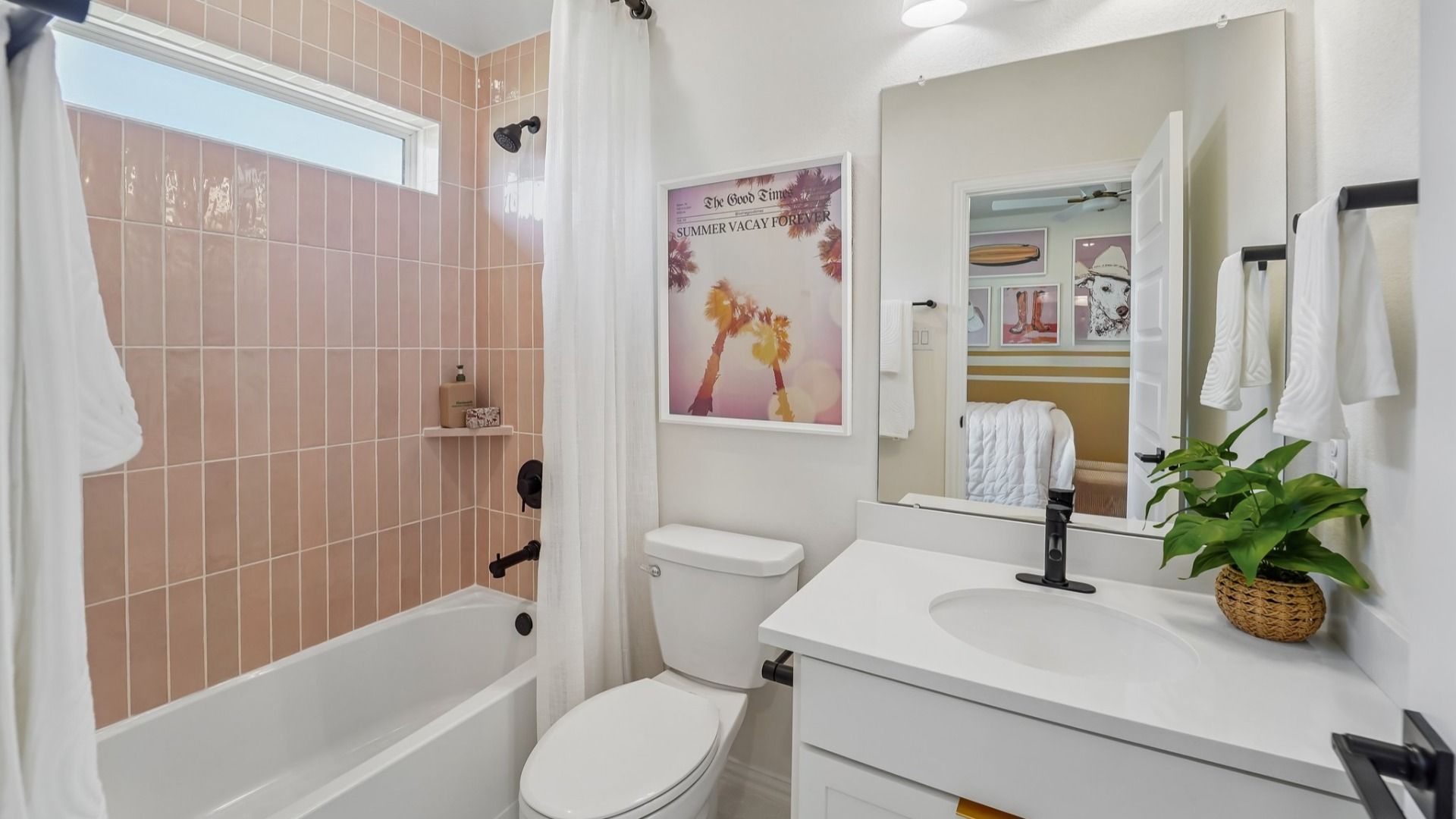 Luxurious bathroom features elegant pink tiles and modern fixtures in The Woodlands Hills.