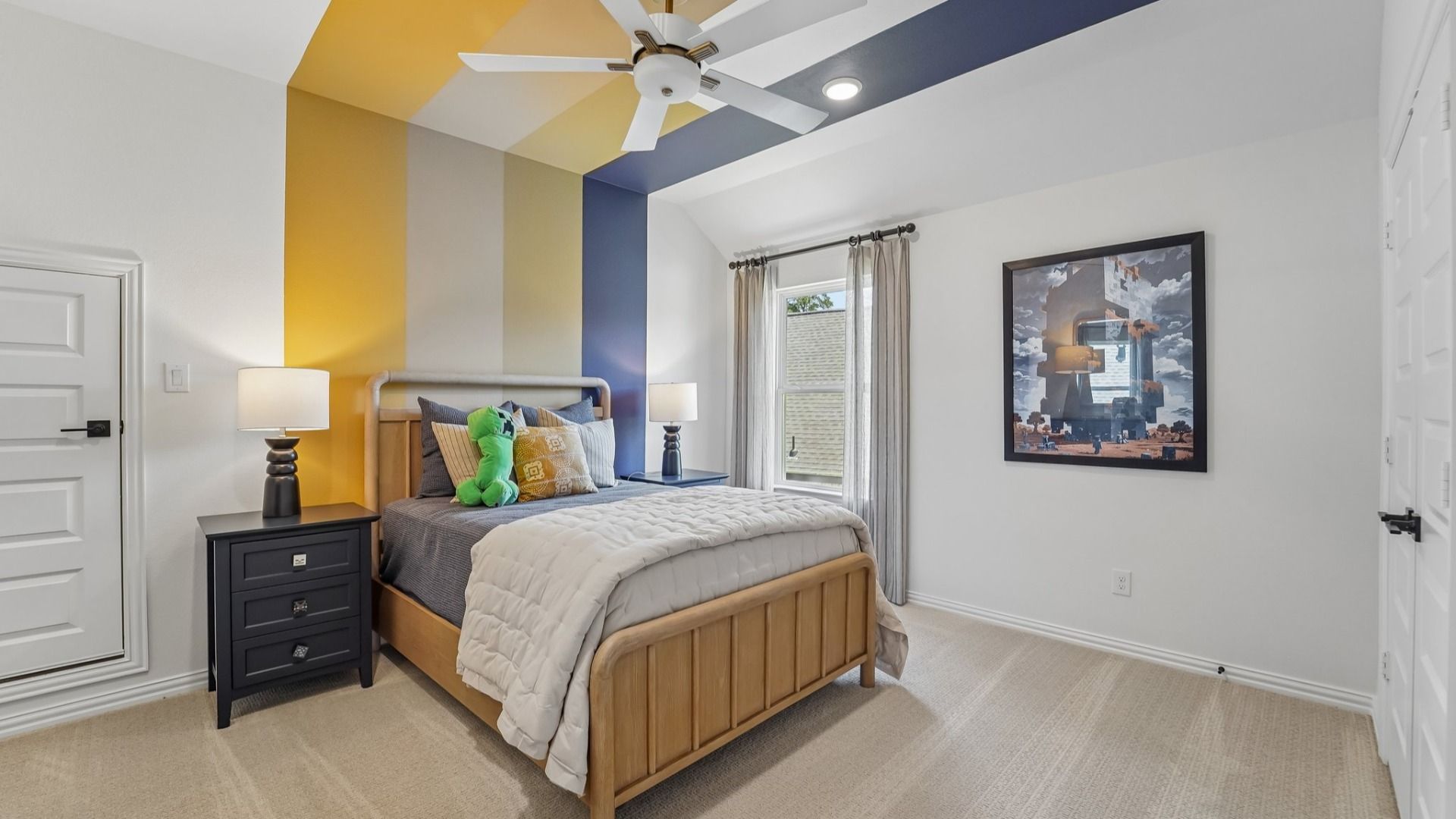 Luxurious bedroom features striking striped accent wall and plush furnishings in The Woodlands Hills, Texas.