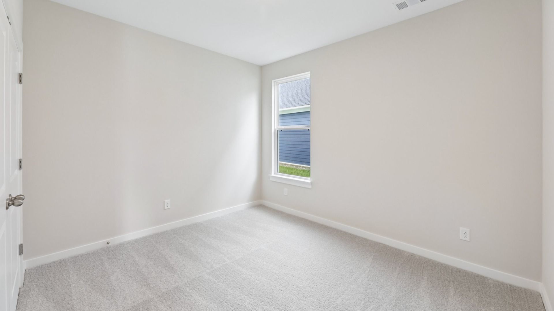 Bedroom with window and carpet