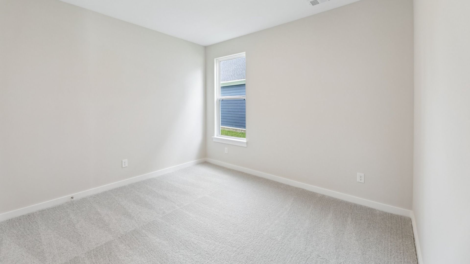 Bedroom with window and carpet