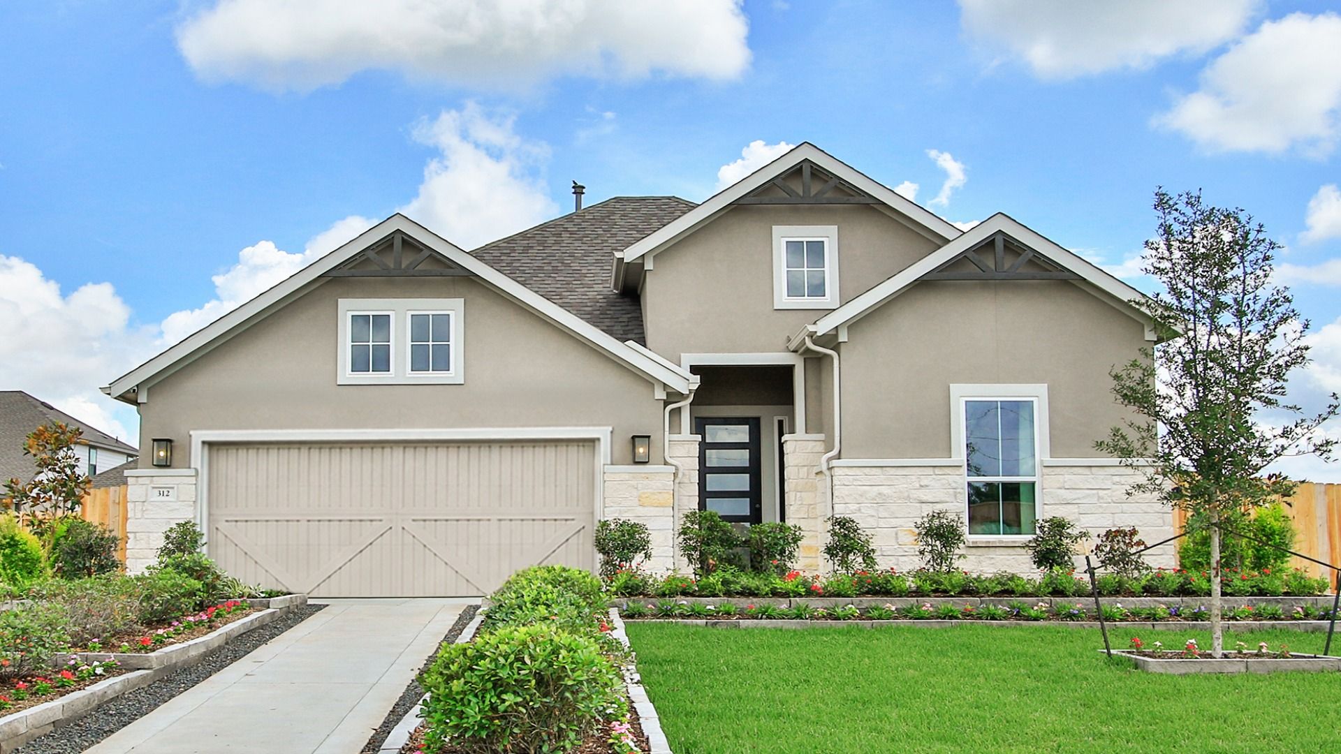 Single-story home featuring an elegant stone and stucco exterior in Azalea community.