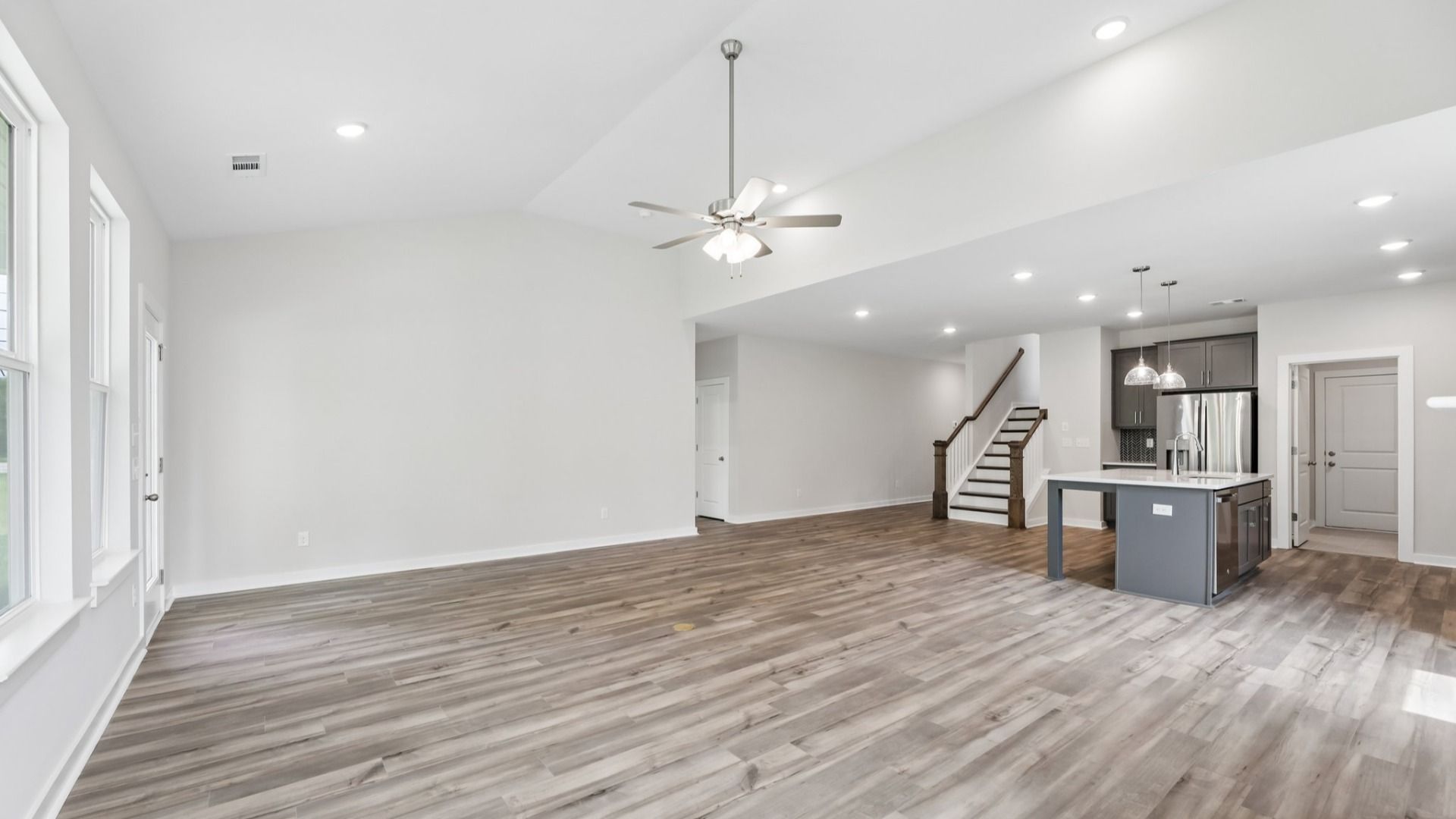 View of kitchen, gathering room, and staircase