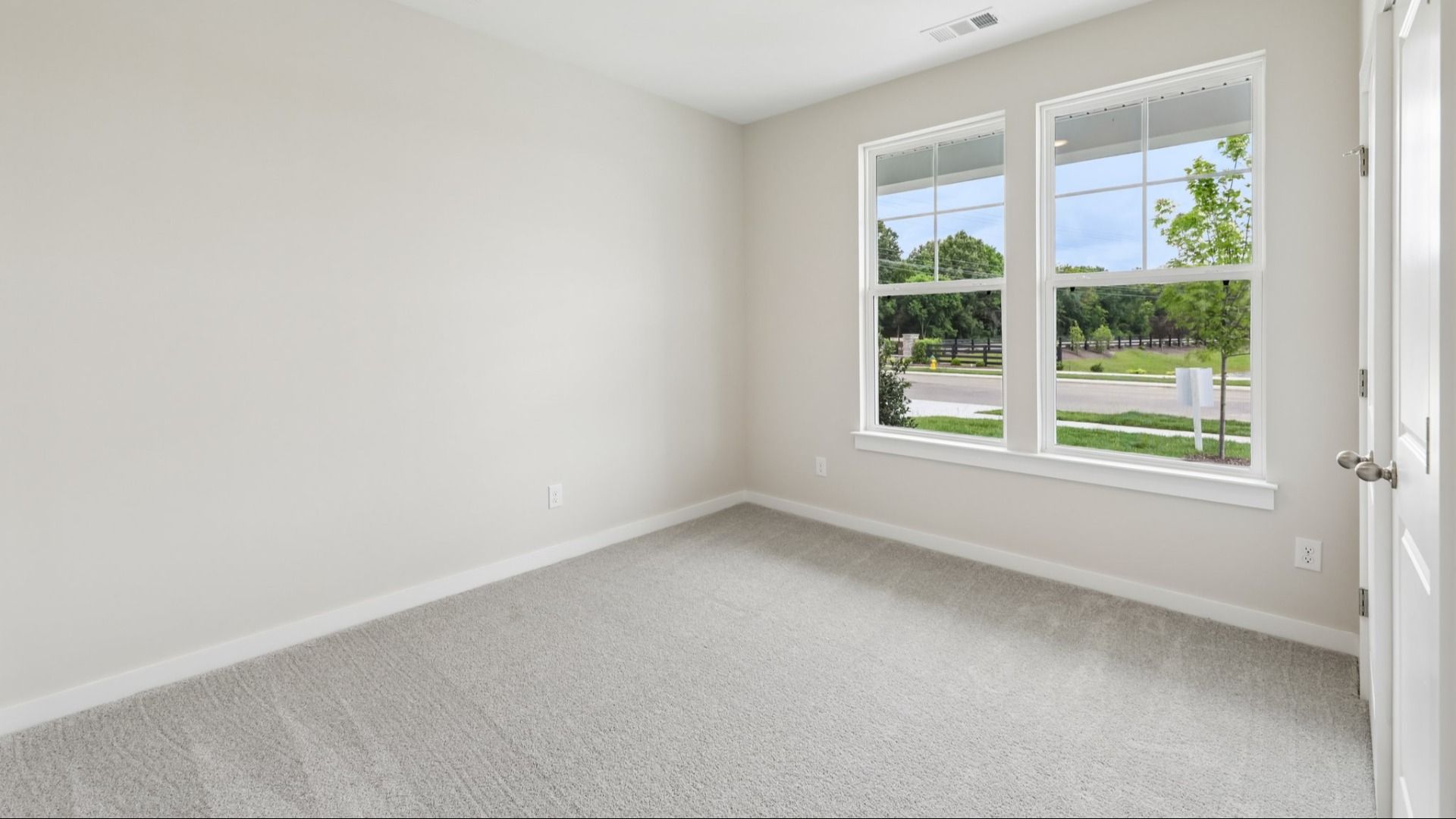 Bedroom with carpet and windows