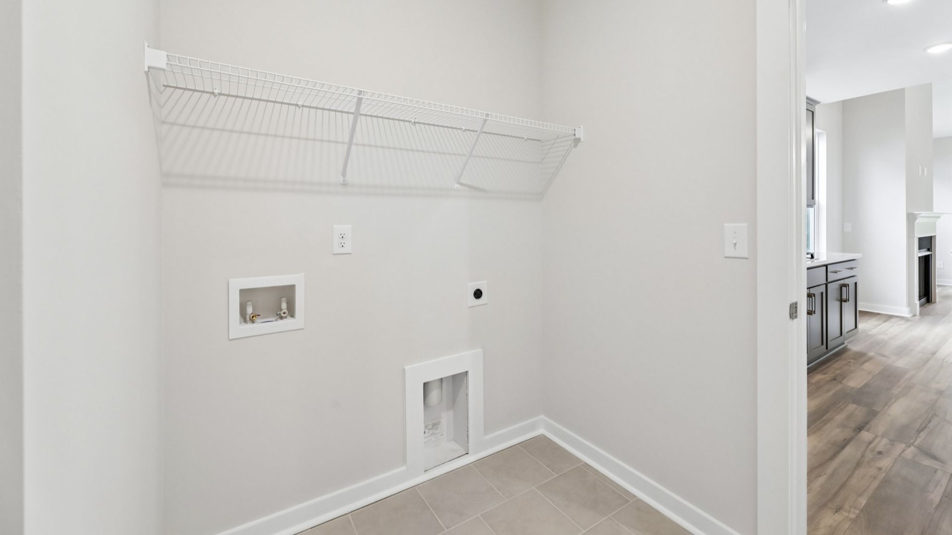 Dedicated laundry room with ventilated shelf