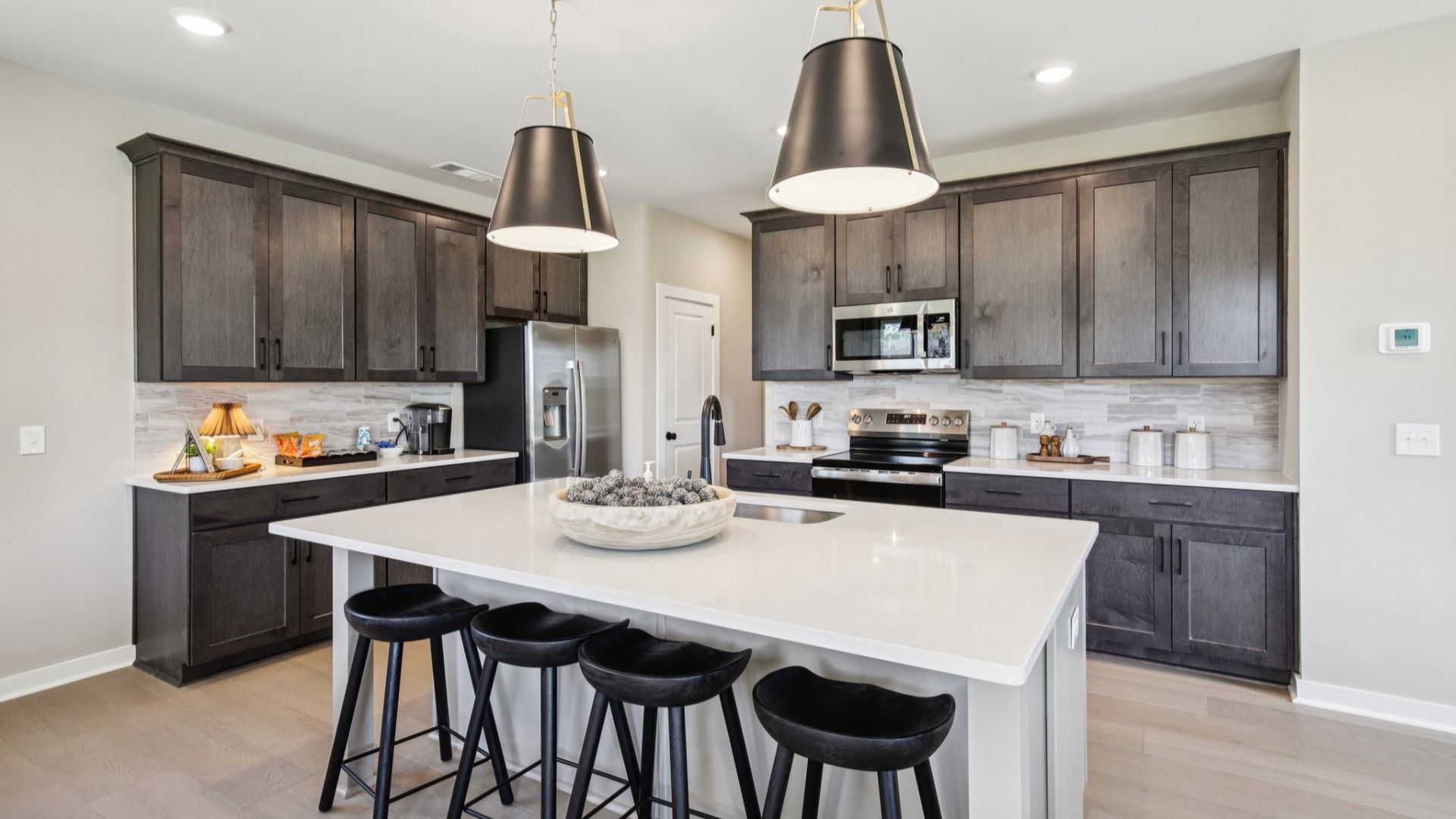 Kitchen with quartz countertops, pendant lighting, and hard-surface flooring