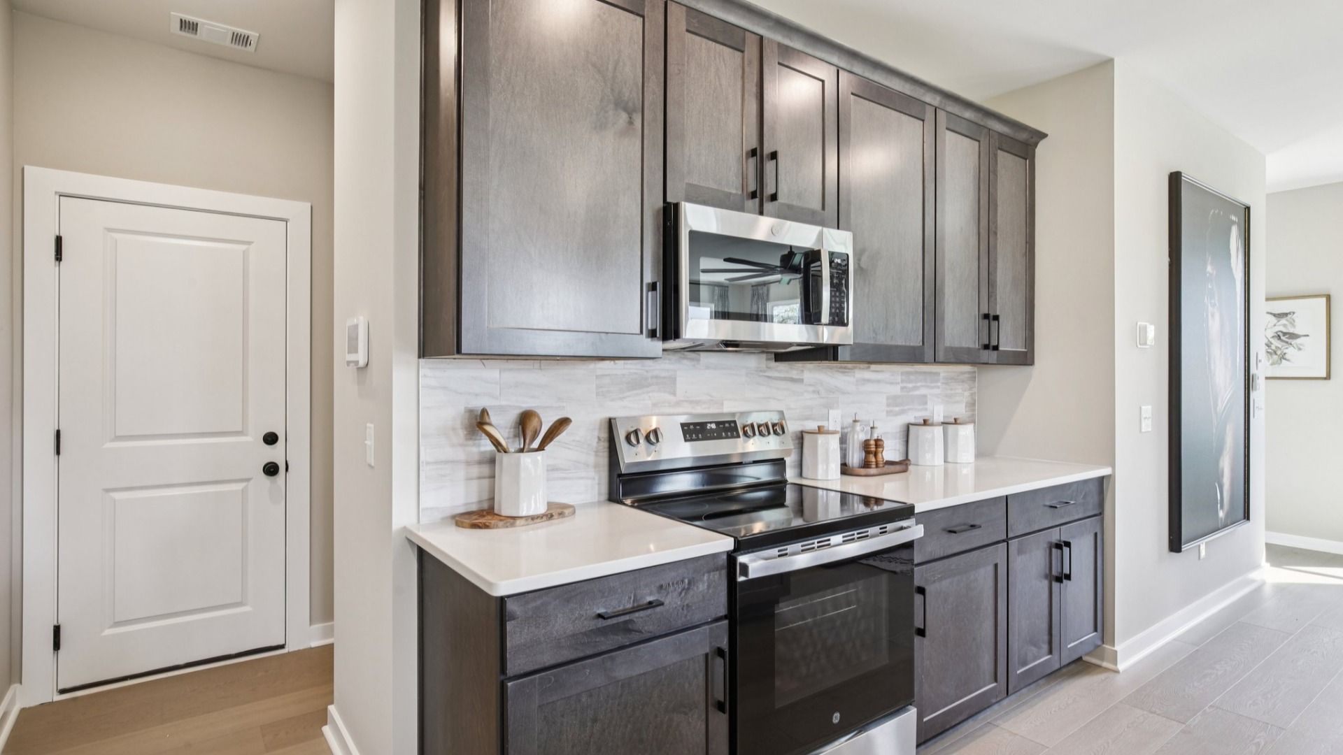 Kitchen with quartz countertops and dark cabinetry