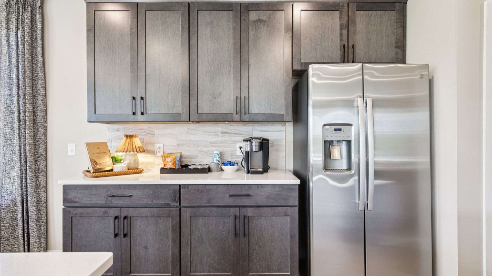 Kitchen with quartz countertops and dark cabinetry