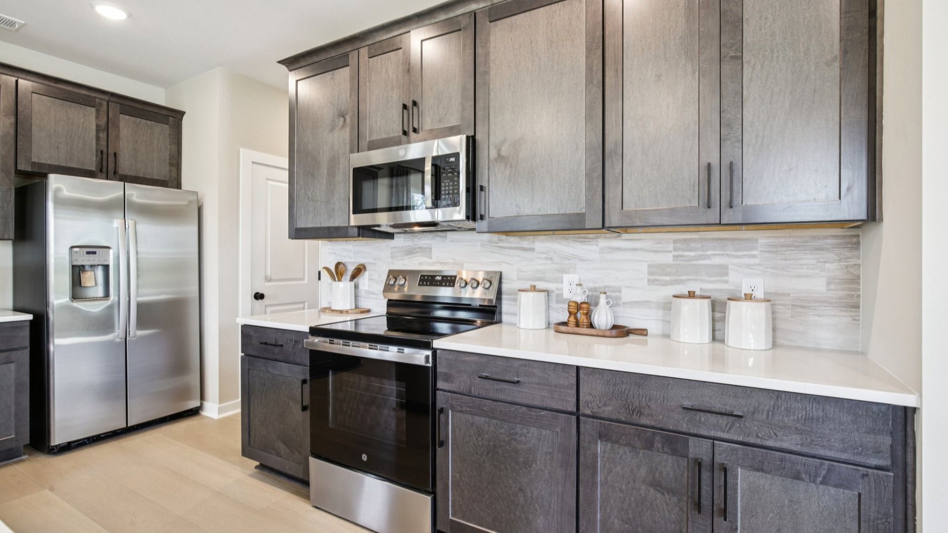 Kitchen with quartz countertops and dark cabinetry