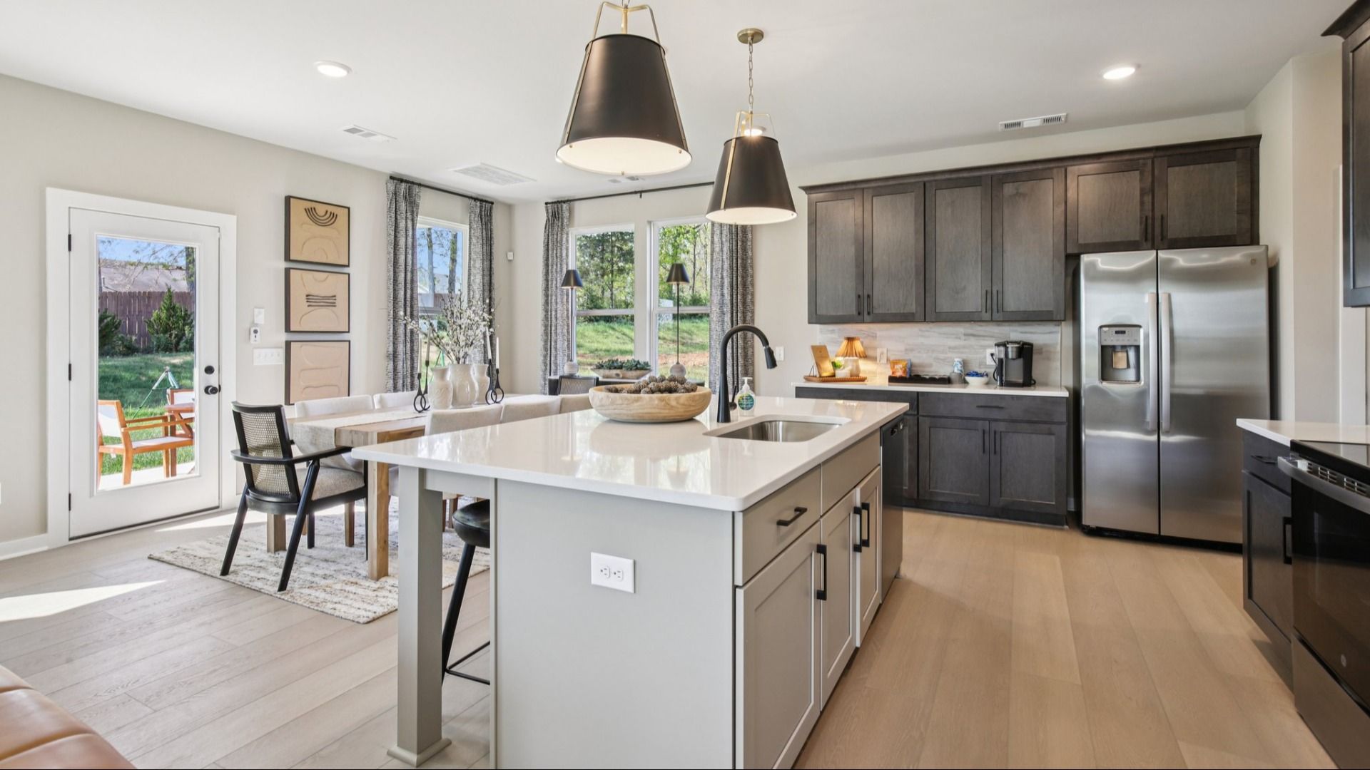 Kitchen with quartz countertops and dark cabinetry