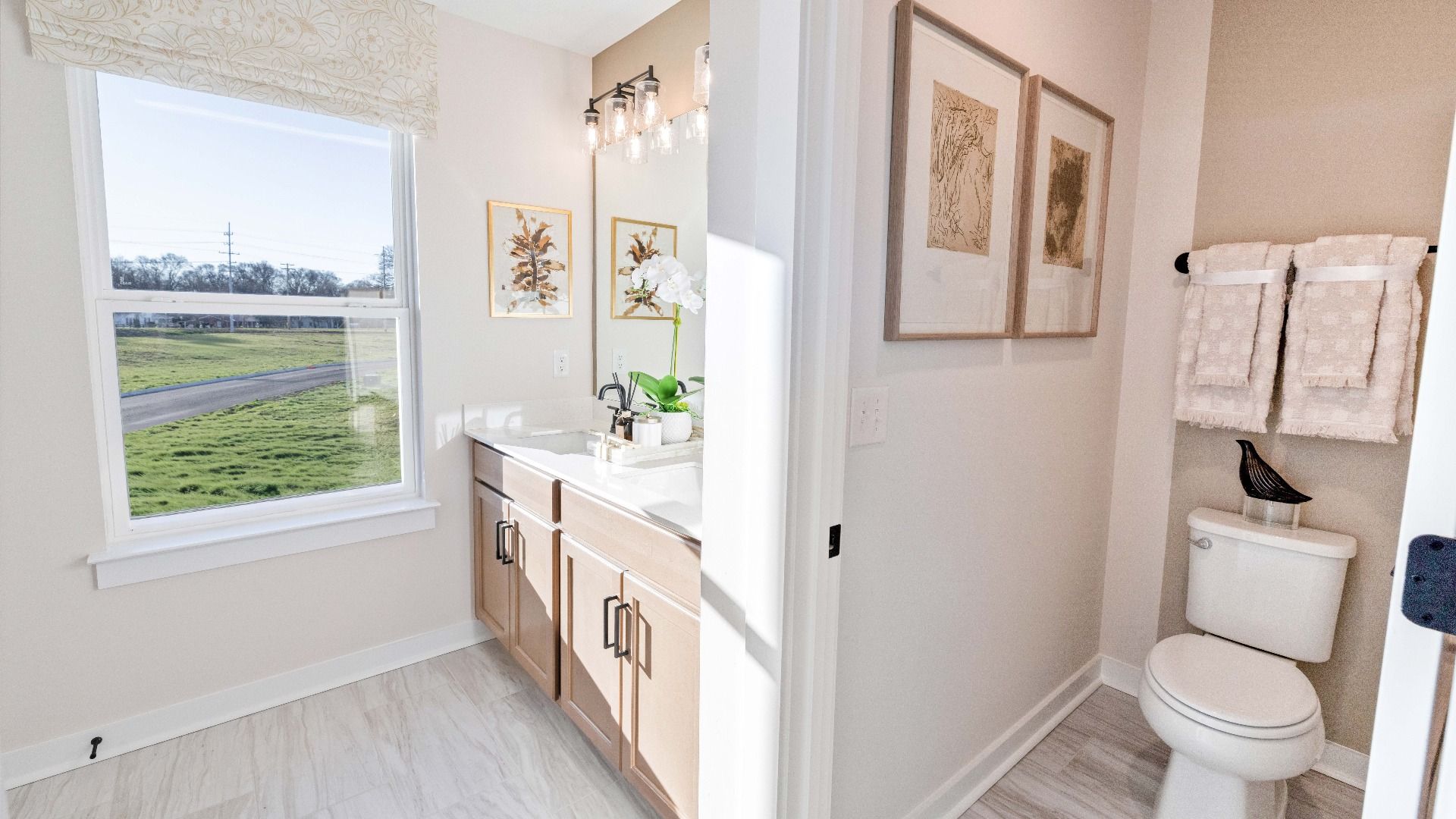 Bathroom with dual vanity and window