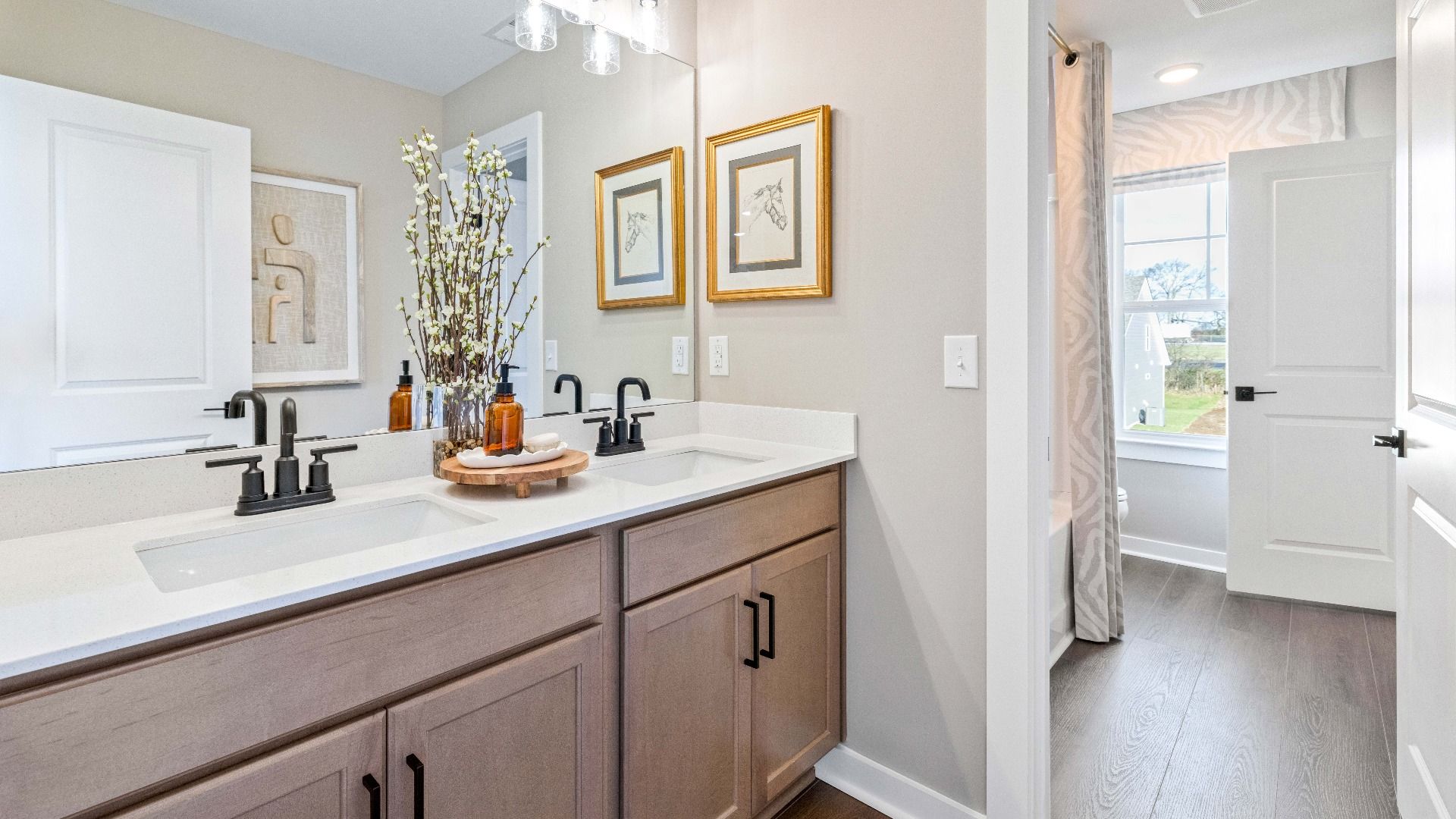 Bathroom with dual vanity and window