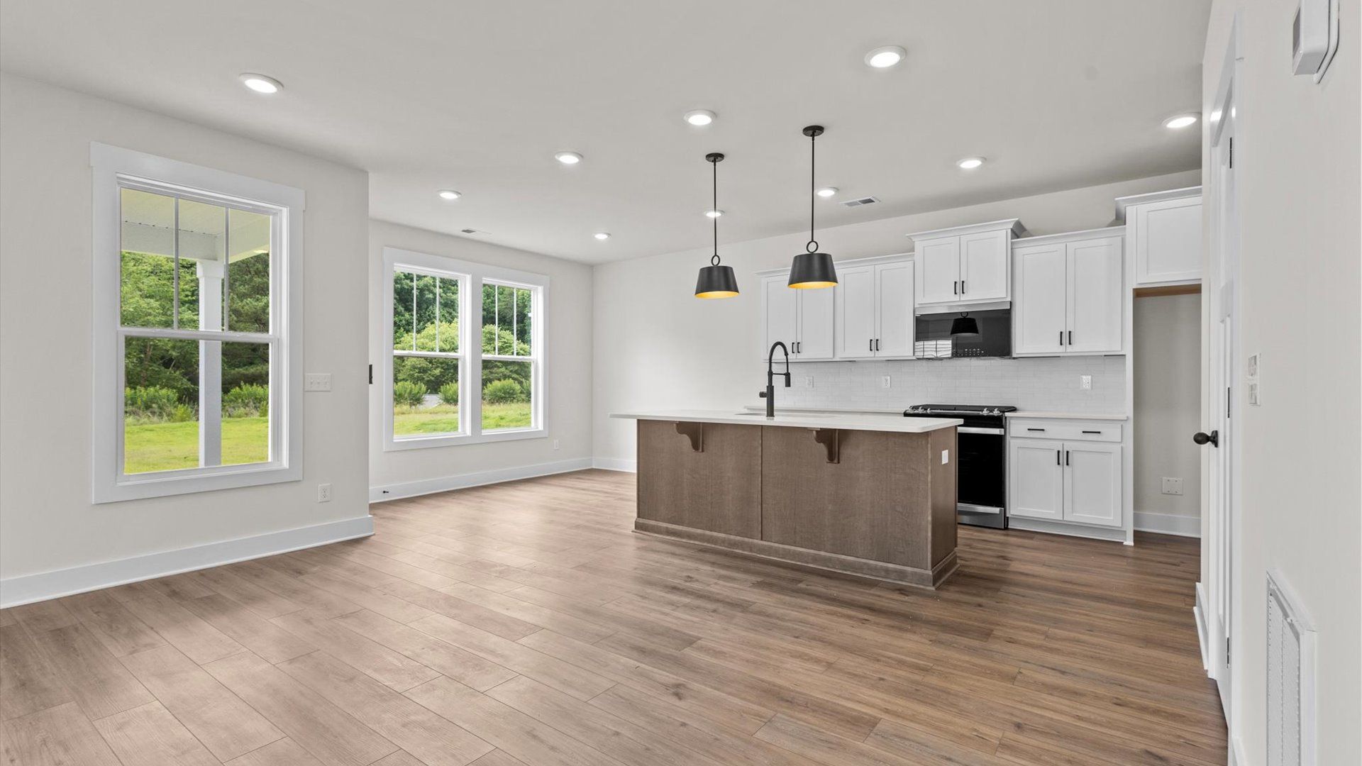 Kitchen with quartz countertops, pendant lighting, and hard surface flooring