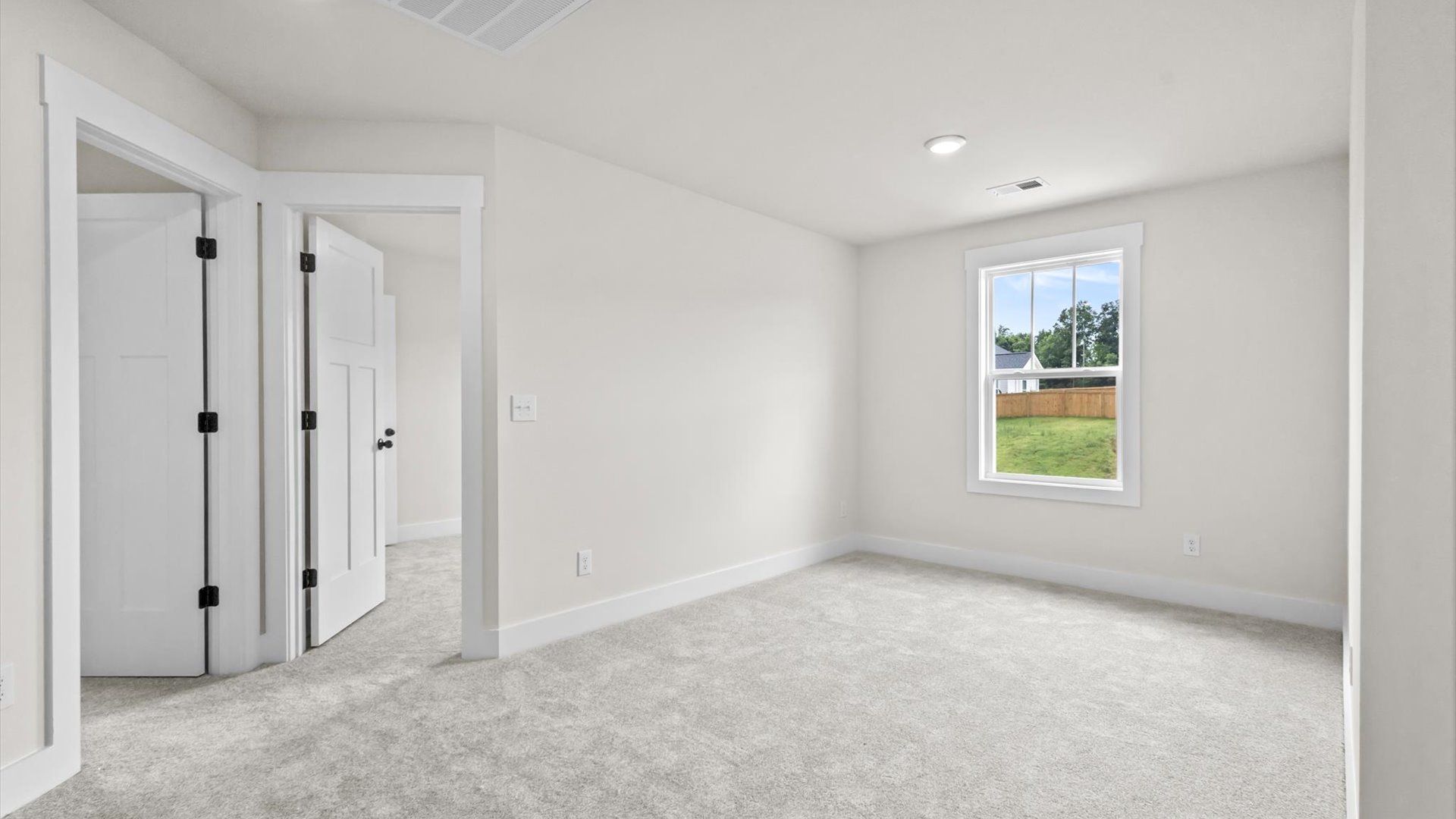 Bedroom with carpet and window