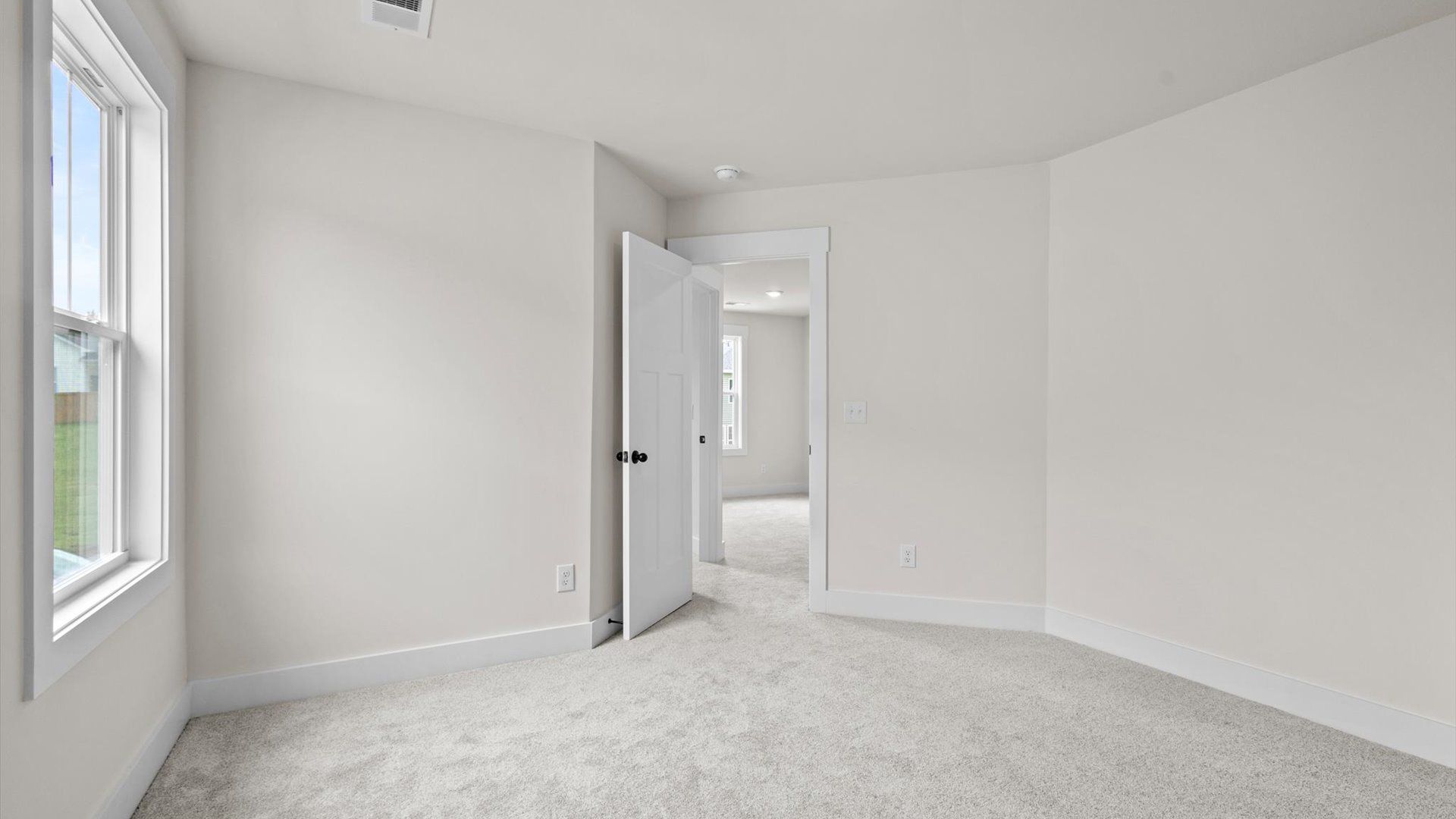 Bedroom with carpet and window