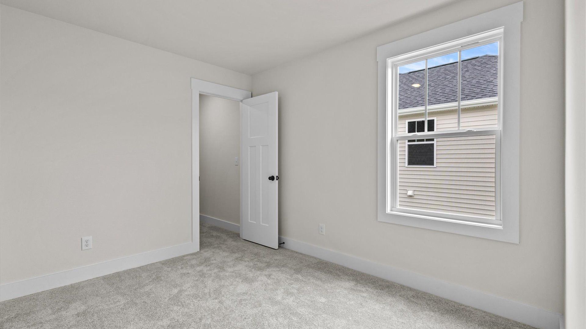 Bedroom with carpet and window