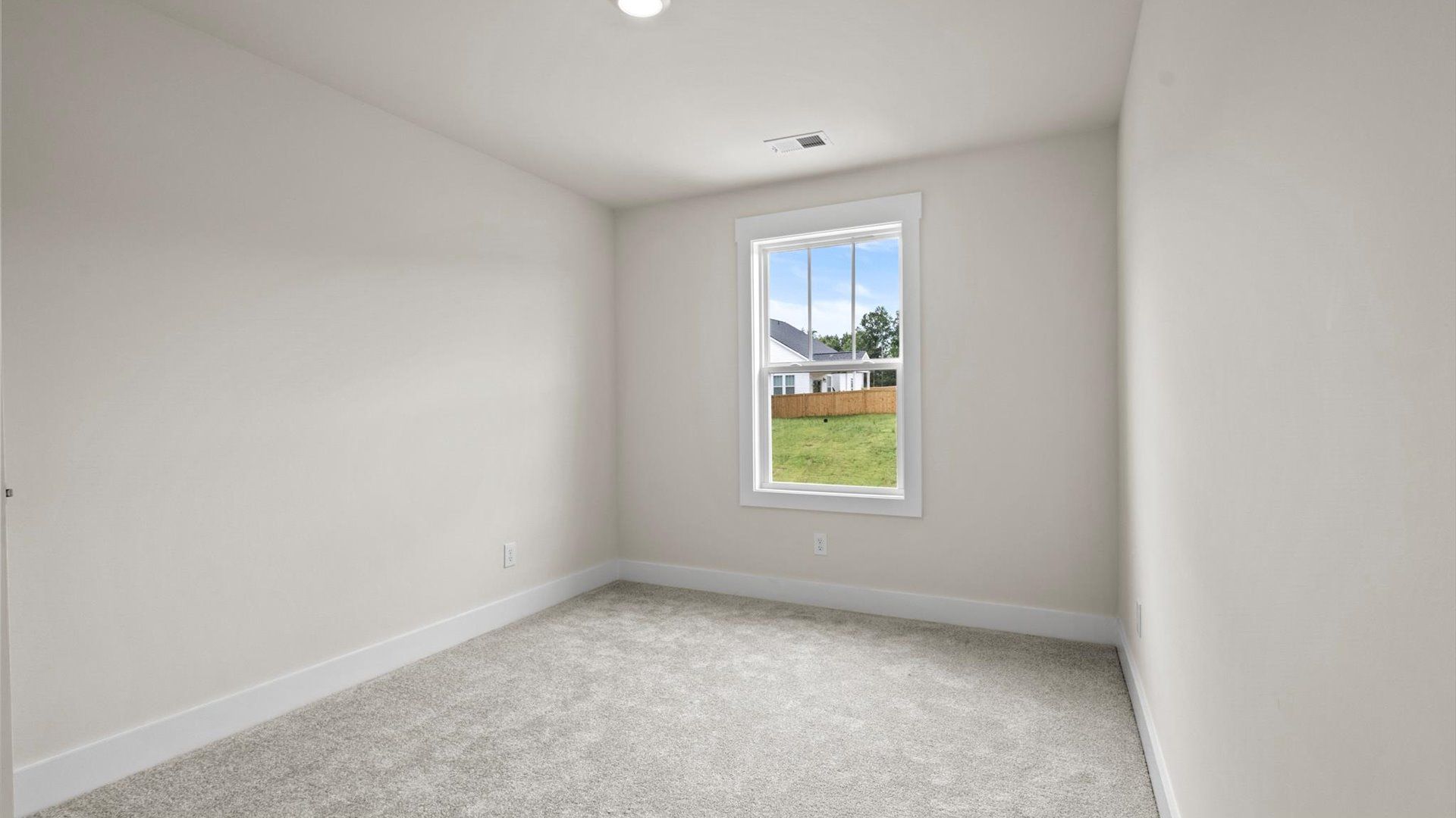 Bedroom with carpet and window