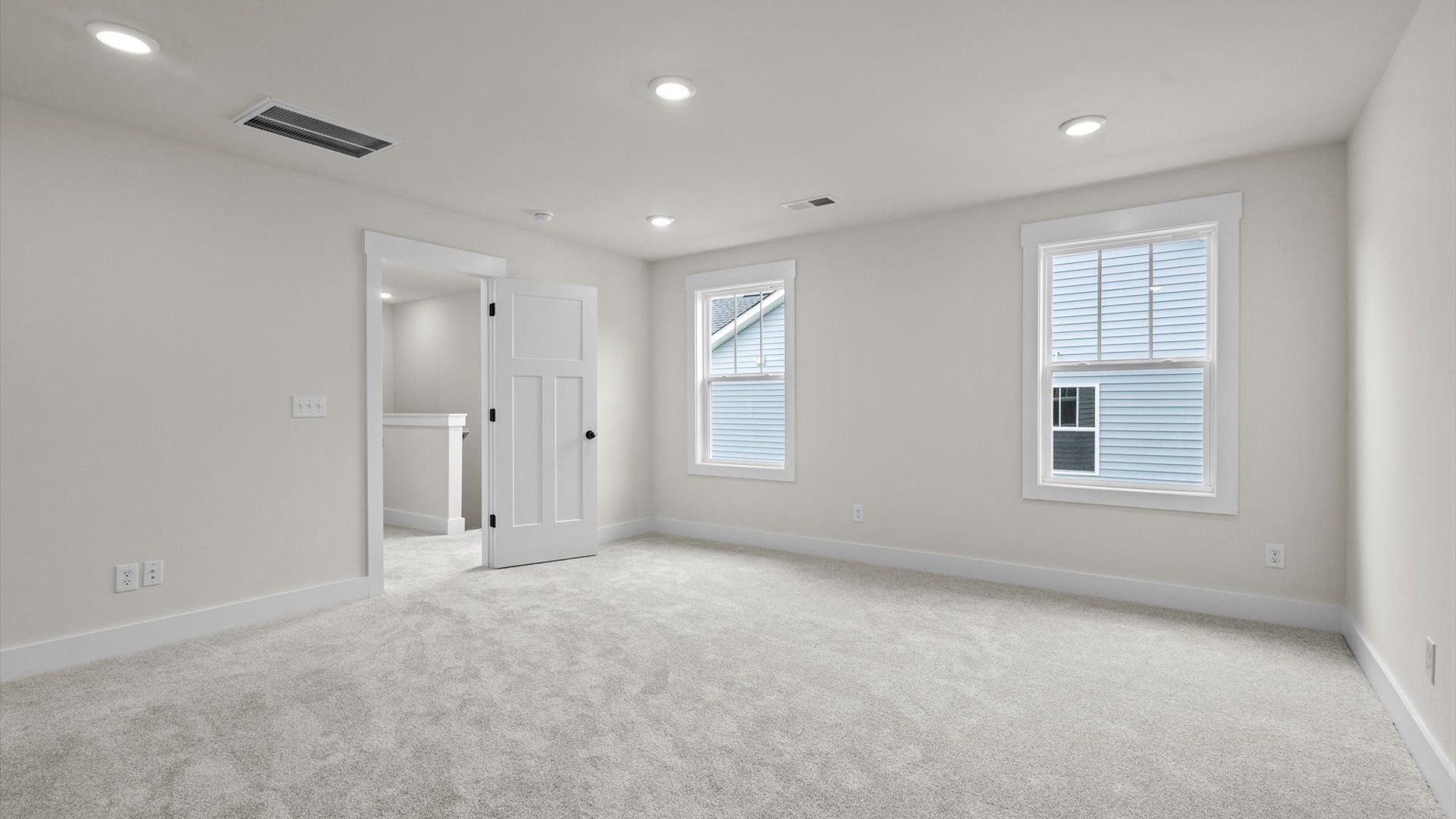 Bedroom with carpet and windows