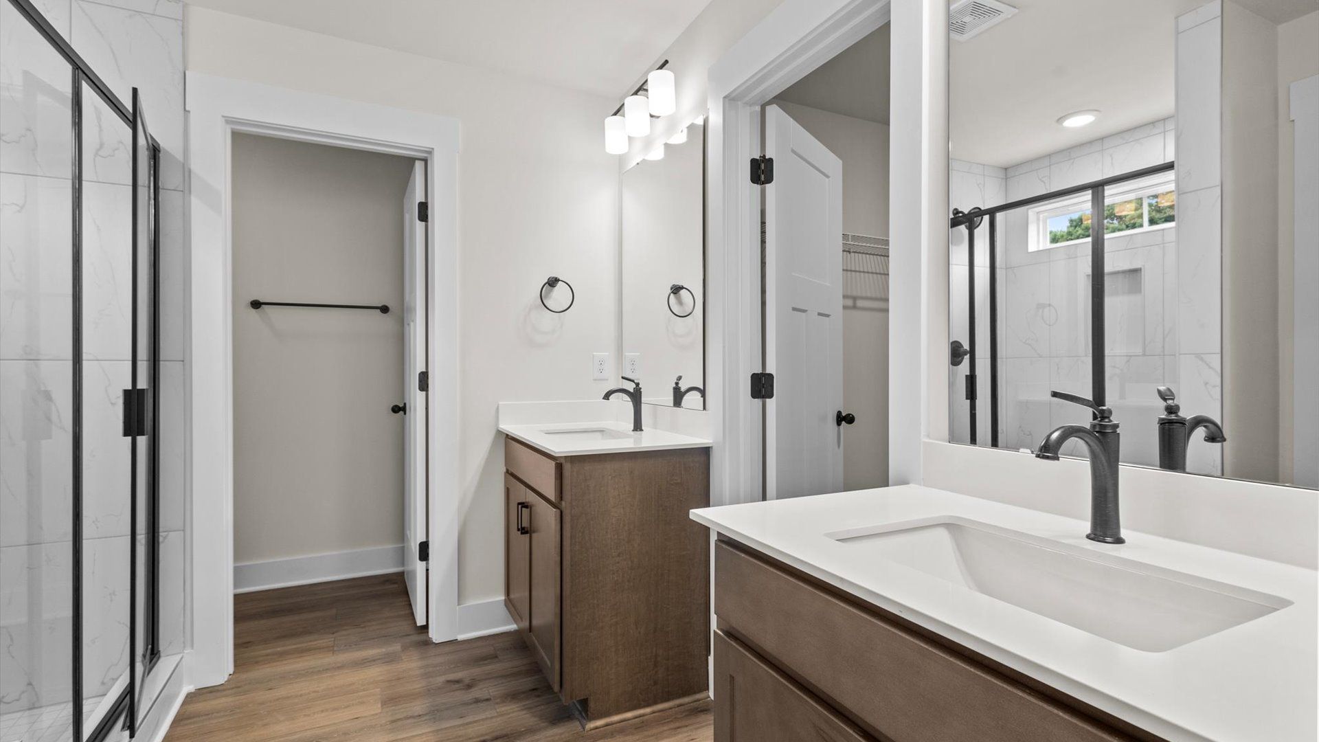 With dual vanity and glass enclosed shower