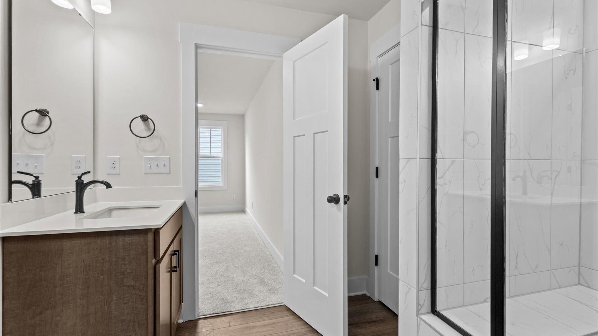 With dual vanity and glass enclosed shower