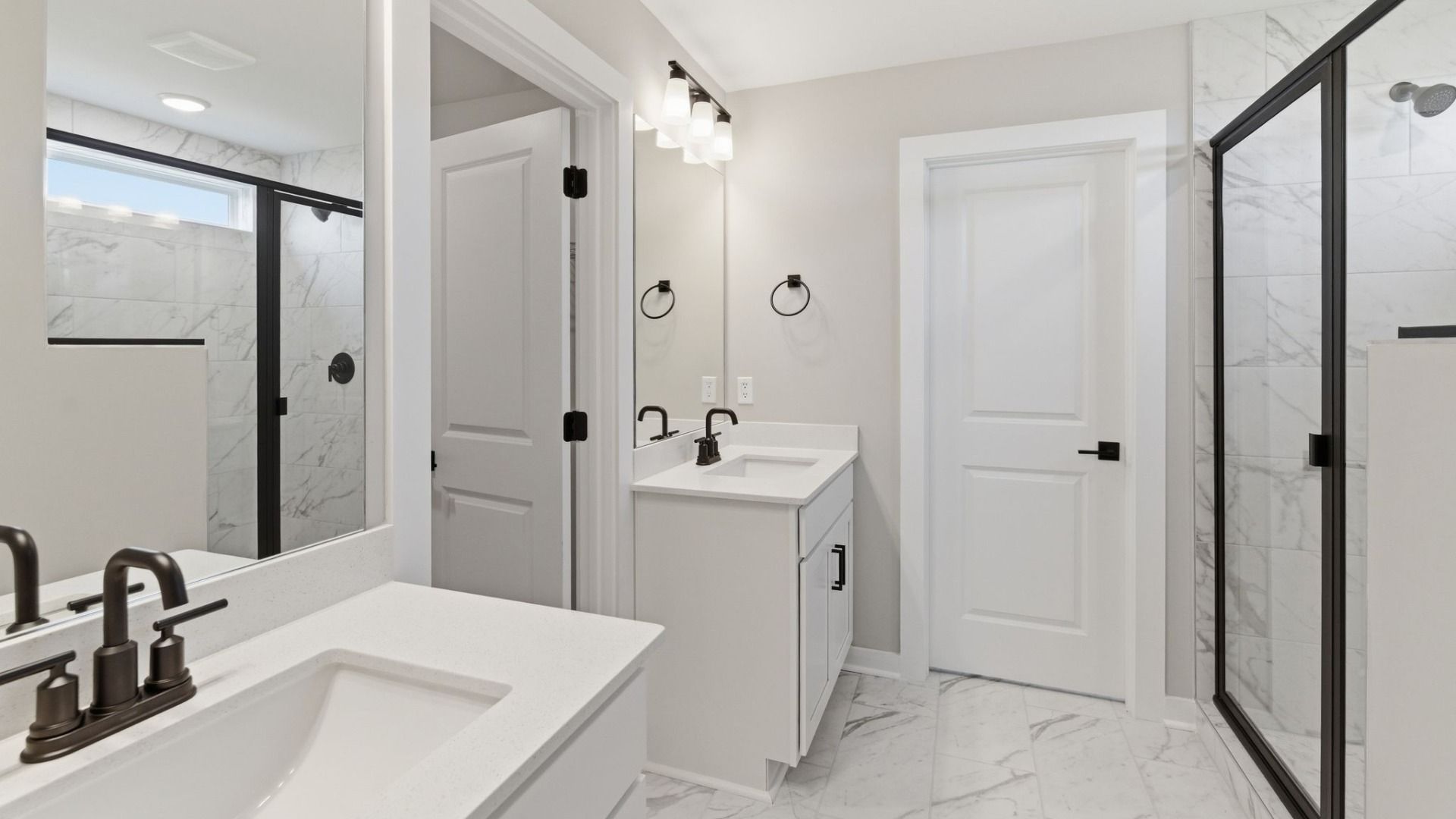 Bathroom with dual vanity and access to primary closet