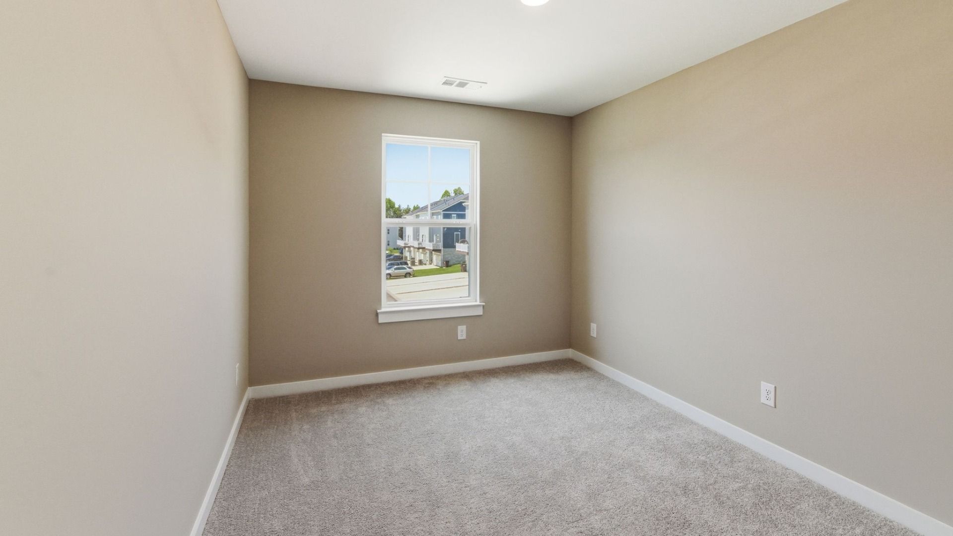 Bedroom with carpet and window