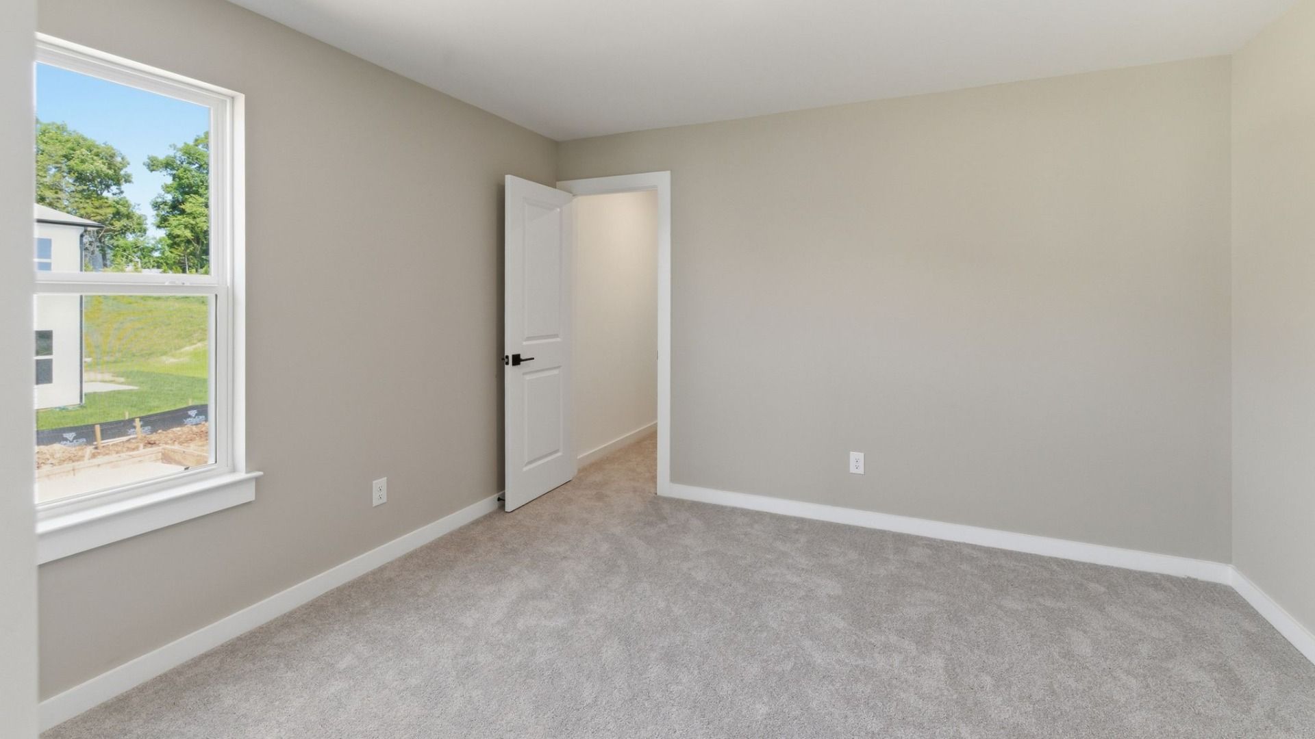 Bedroom with carpet and window