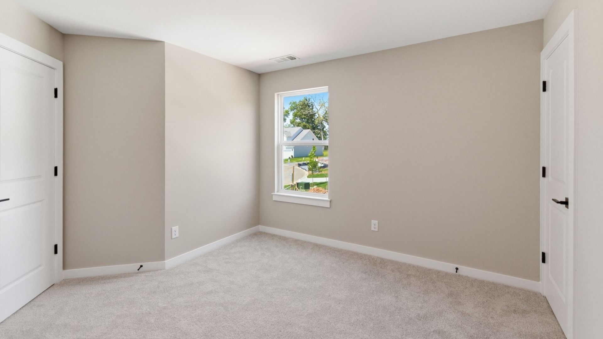 Bedroom with carpet and window