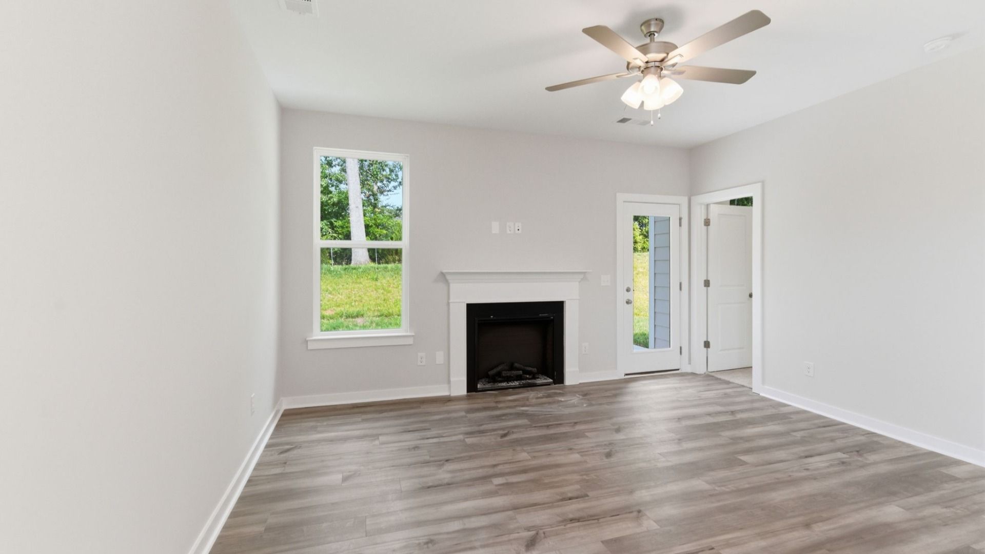 Gathering room with ceiling fan and fireplace