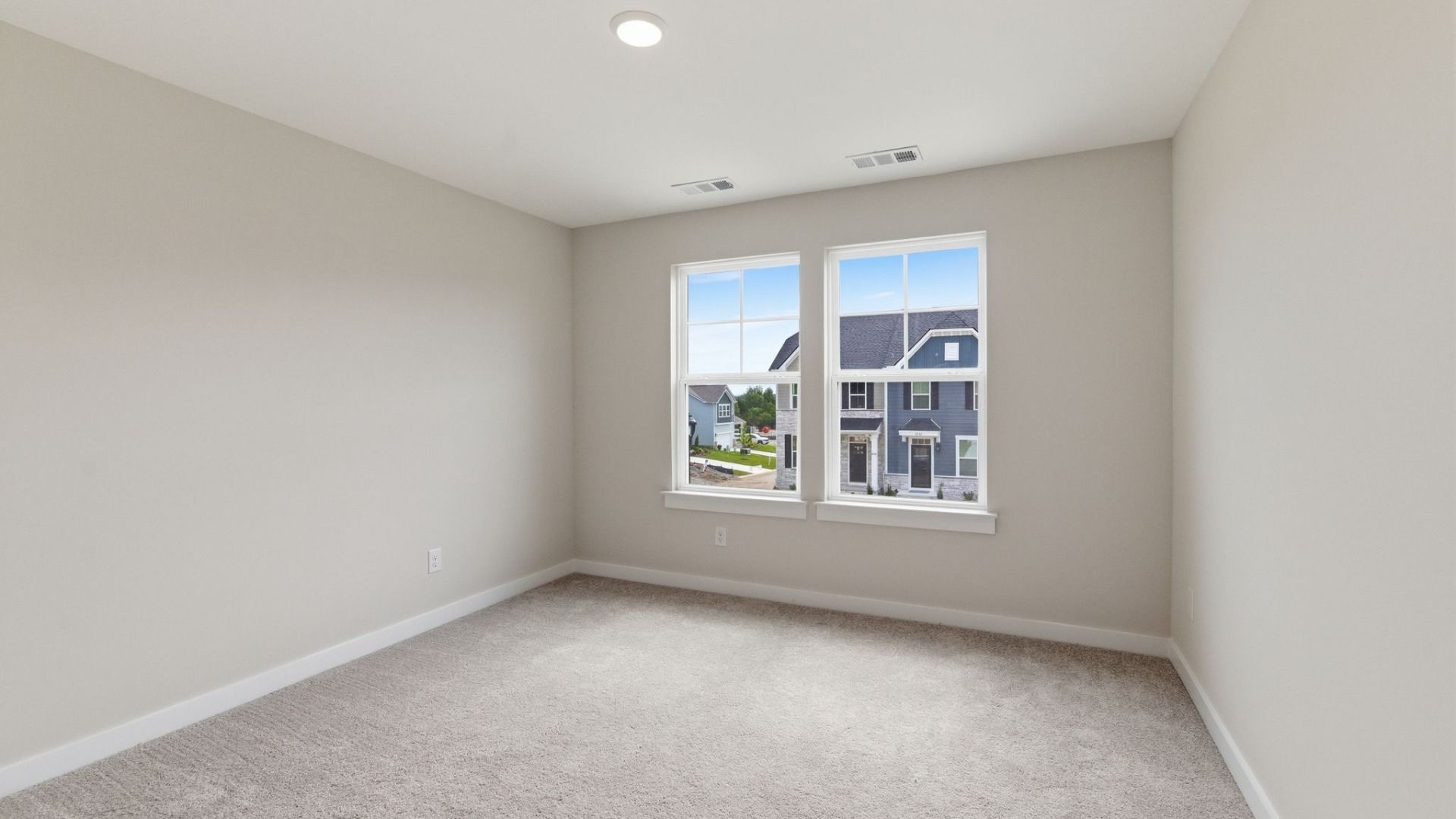 Bedroom with carpet and windows