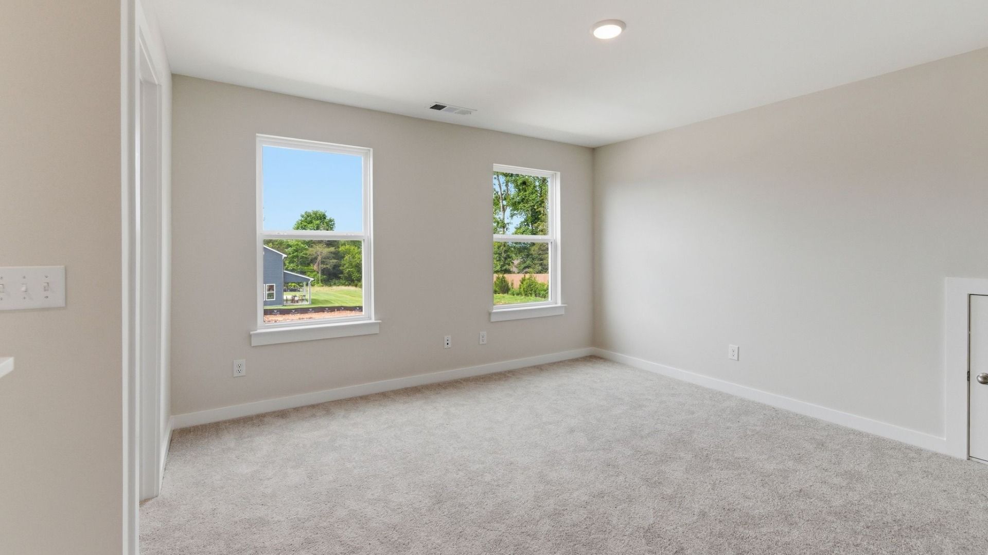 Loft area with carpet and windows