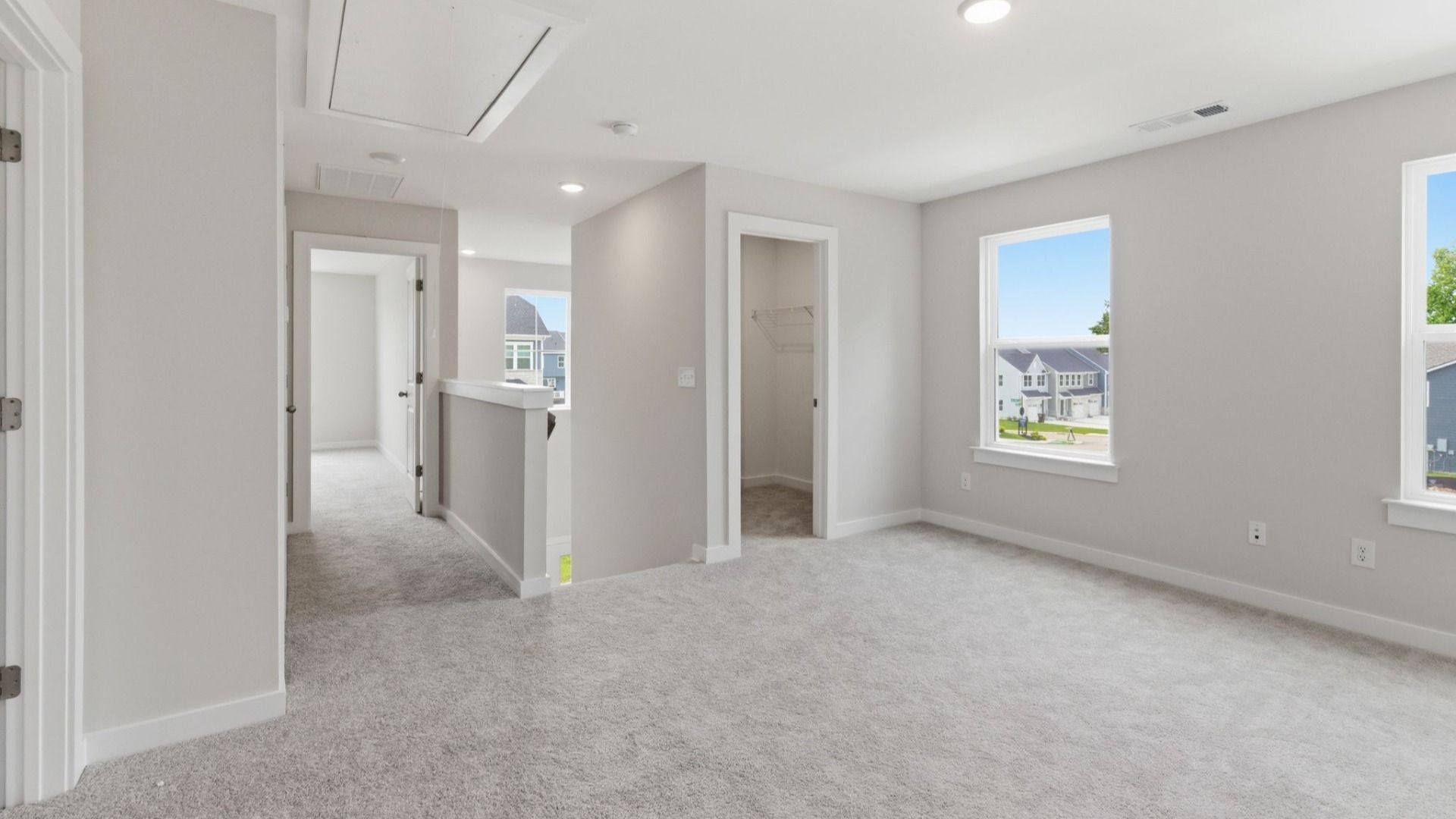 Loft area with carpet and windows