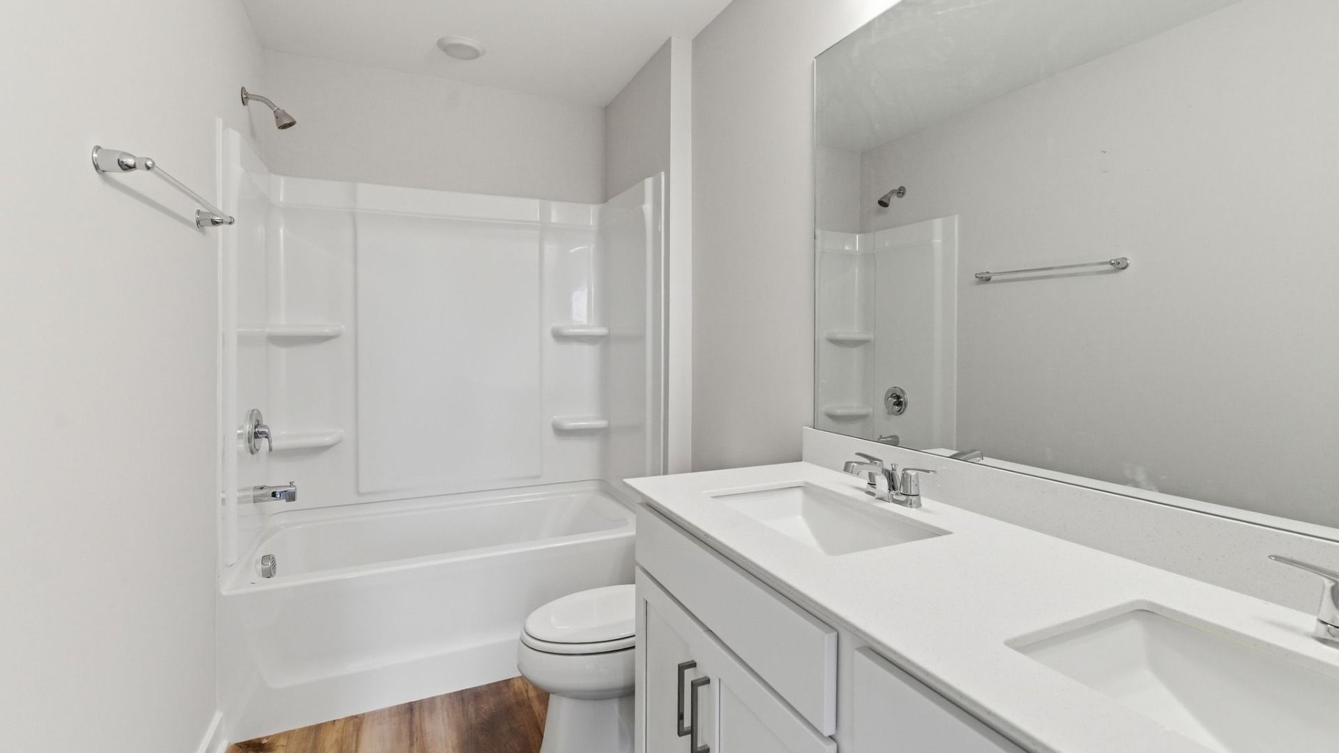 Bathroom with hard surface flooring and dual vanity