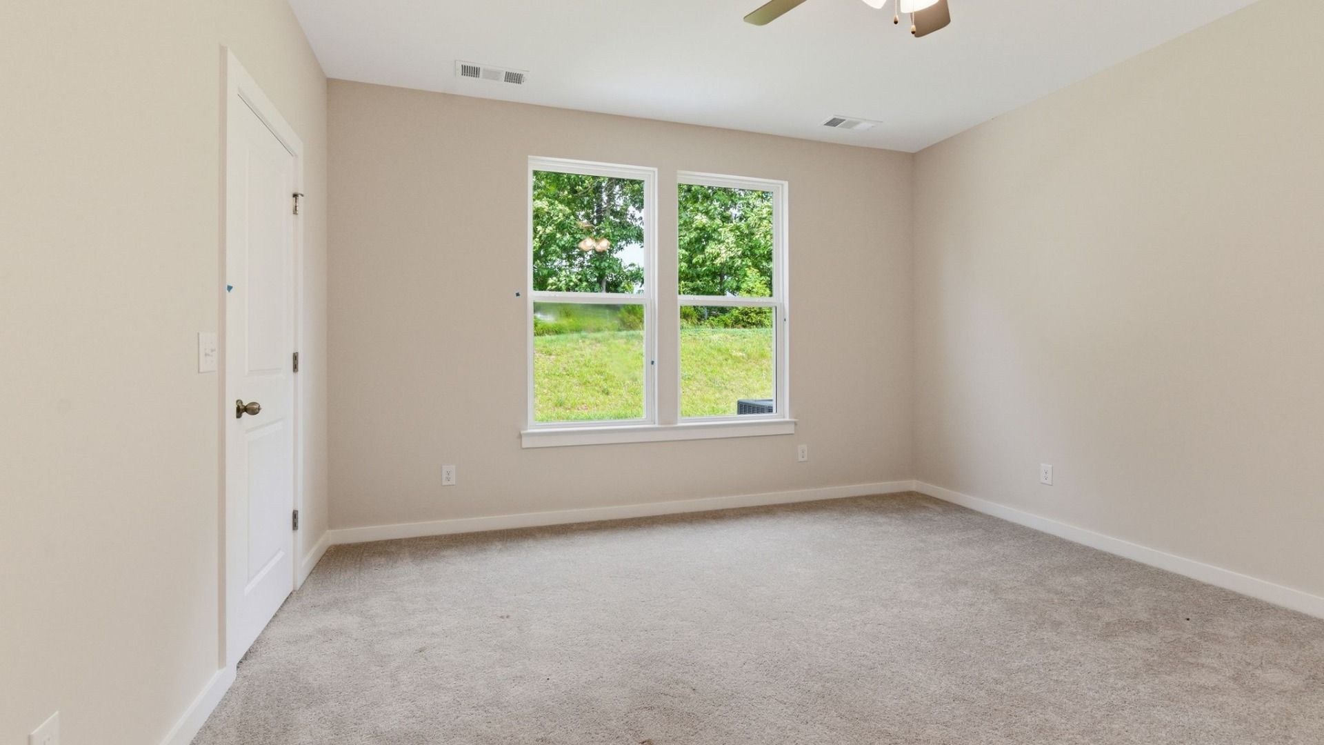 Bedroom with carpet and windows