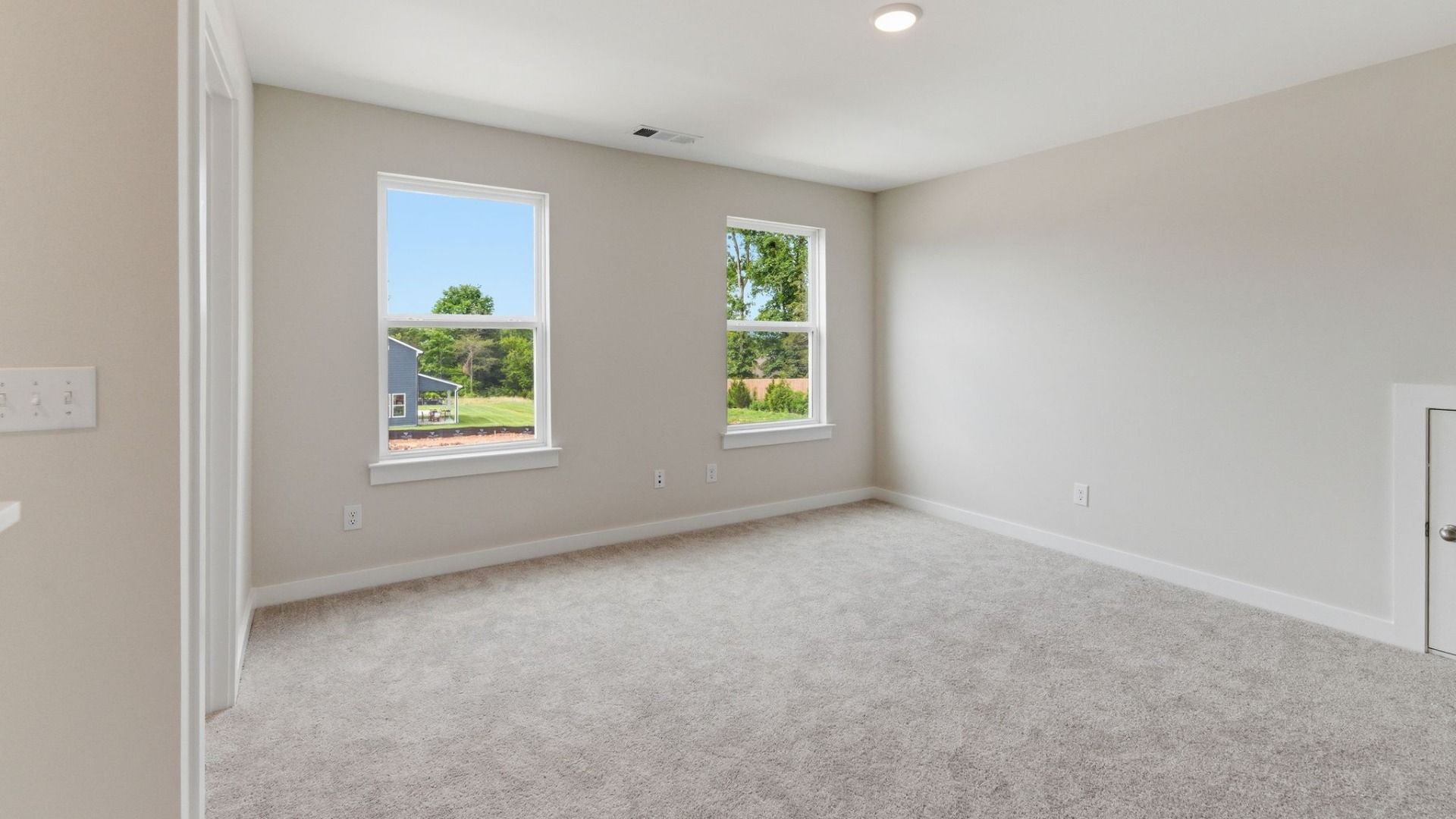 Loft with carpet and windows
