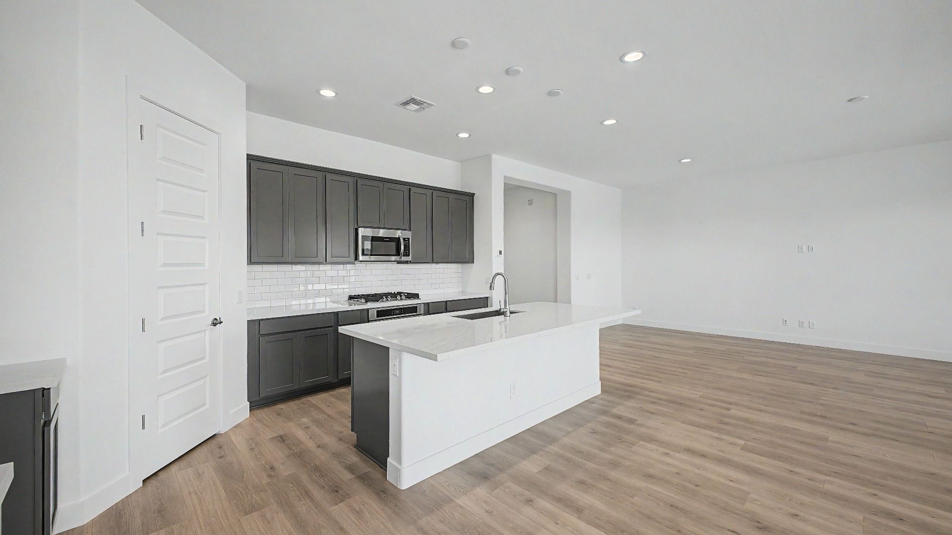 Gourmet kitchen side view new move-in ready DRB home at Hacienda at Estrella, 16825 W. Ardmore Road, Goodyear, Arizona 85338