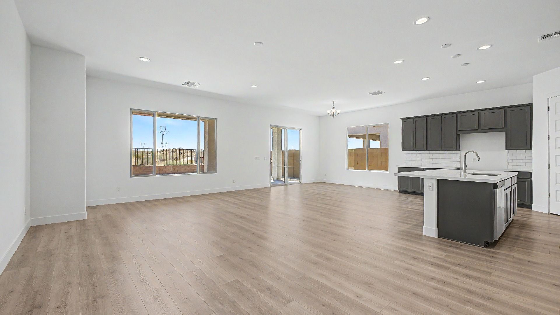 Great room/kitchen in a move-in ready DRB home at Hacienda at Estrella, 16825 W Ardmore Rd, Goodyear, Arizona 85338.