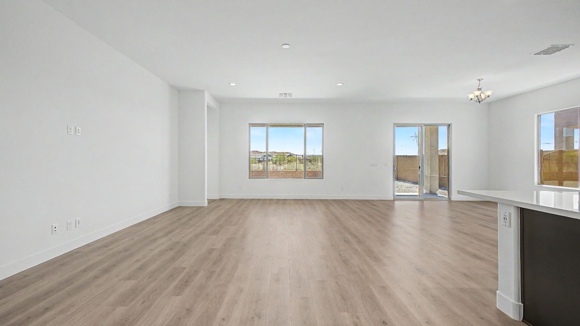 Full great room interior in a move-in ready DRB home at Hacienda at Estrella, 16825 W Ardmore Rd, Goodyear, Arizona 85338.