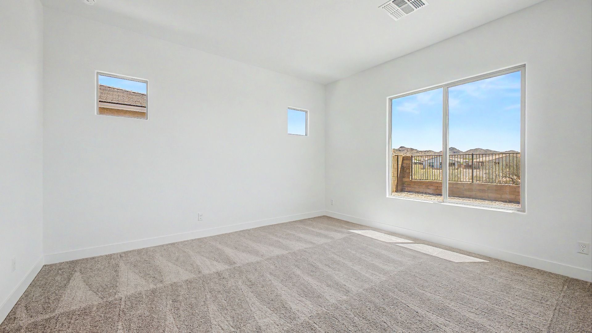 Primary bedroom view in the move-in ready DRB home at Hacienda at Estrella, 16825 W Ardmore Rd, Goodyear, Arizona 85338.