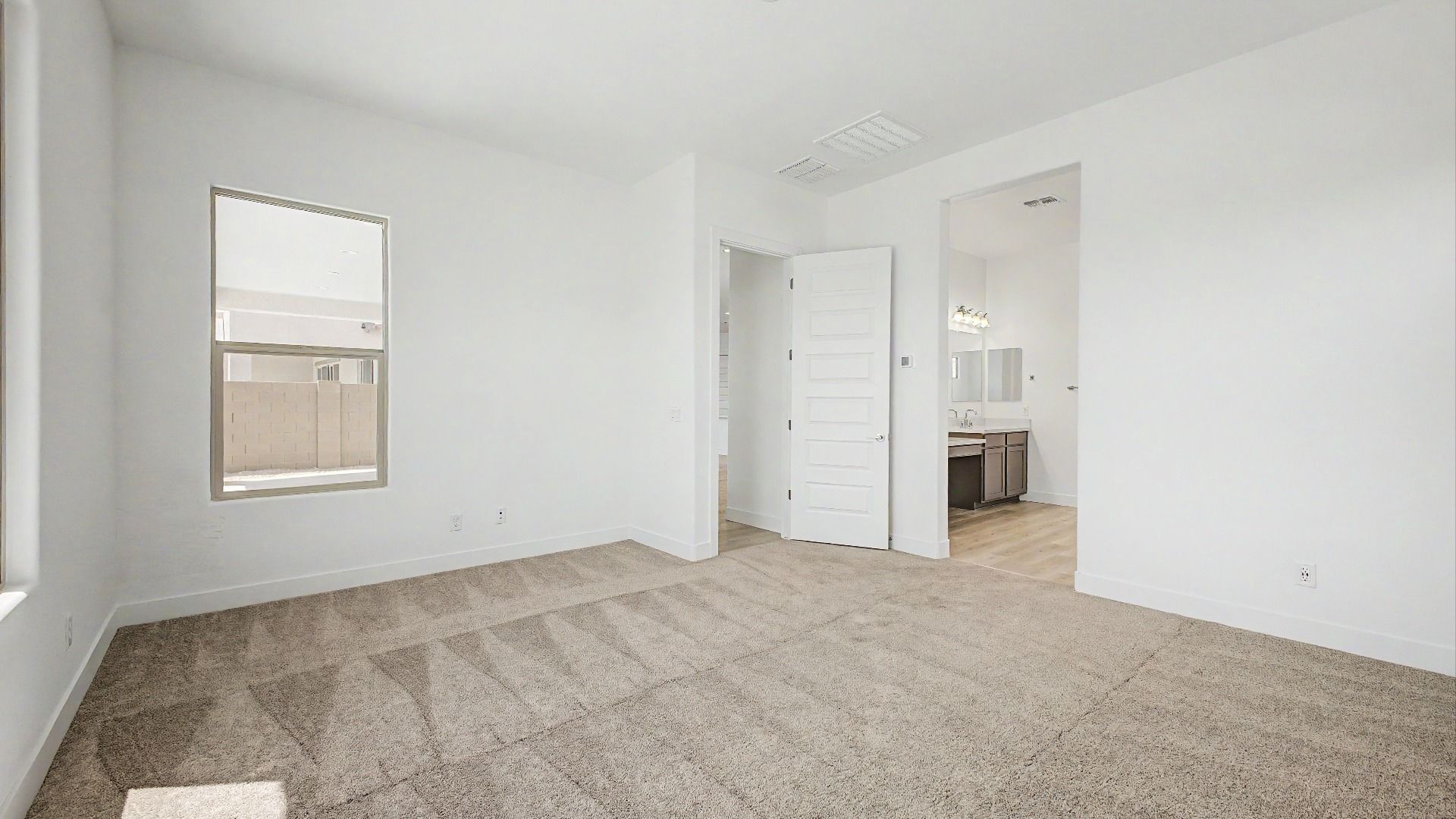 Primary bedroom in the move-in ready DRB home at Hacienda at Estrella, 16825 W Ardmore Rd, Goodyear, Arizona 85338.
