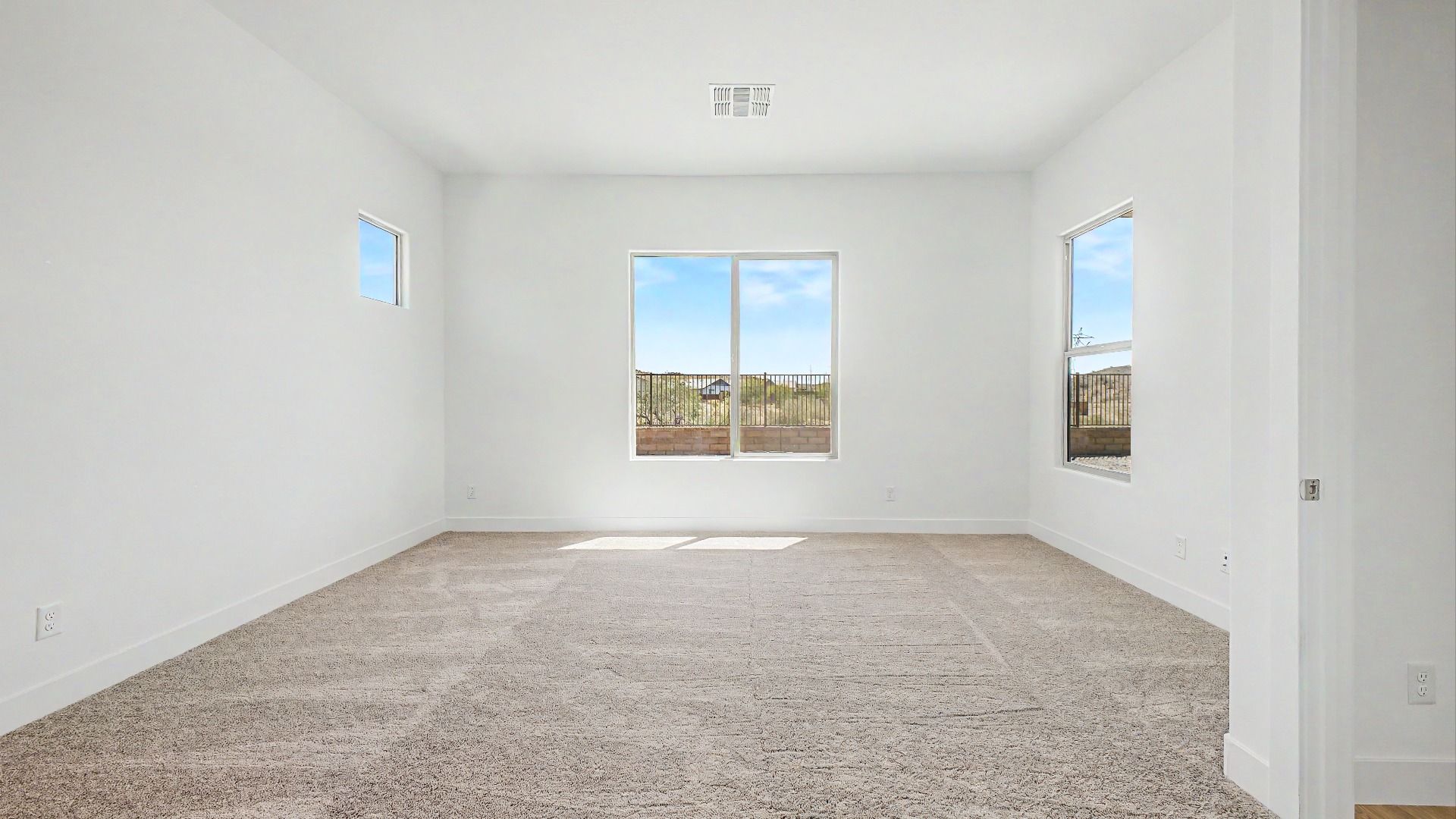 Primary bedroom side view in the move-in ready DRB home at Hacienda at Estrella, 16825 W Ardmore Rd, Goodyear, Arizona 85338.