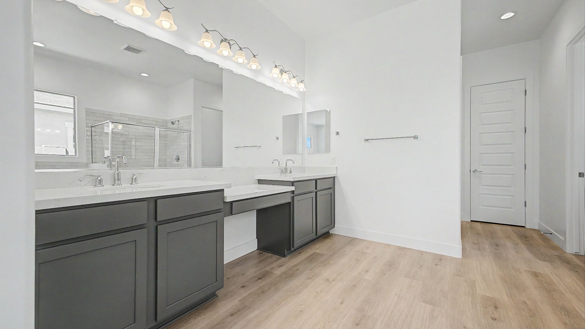 Primary bathroom view one in the move-in ready DRB home at Hacienda at Estrella, 16825 W Ardmore Rd, Goodyear, Arizona 85338.