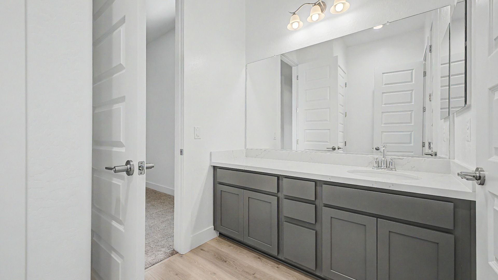 Secondary bathroom vanity in the move-in ready DRB home at Hacienda at Estrella, 16825 W Ardmore Rd, Goodyear, Arizona 85338