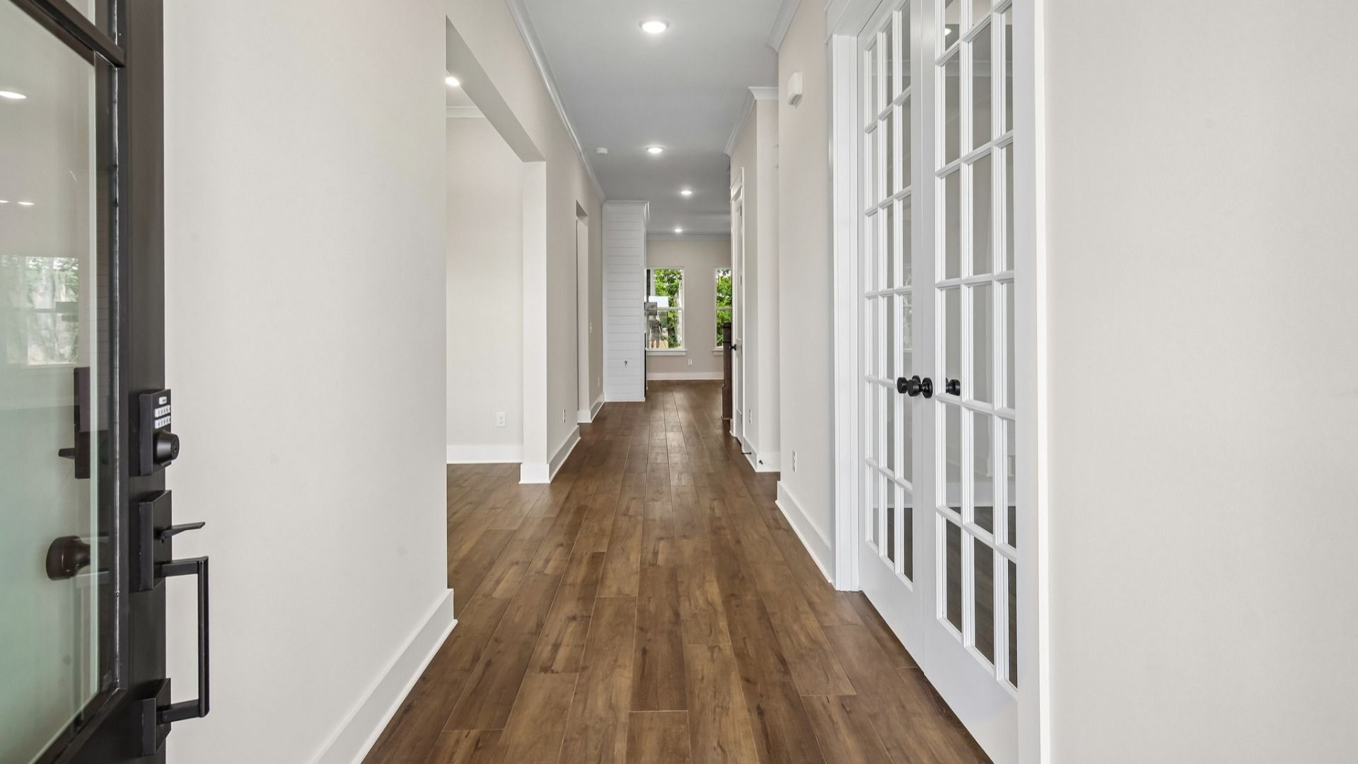 Interior front entry with access to study area with French doors
