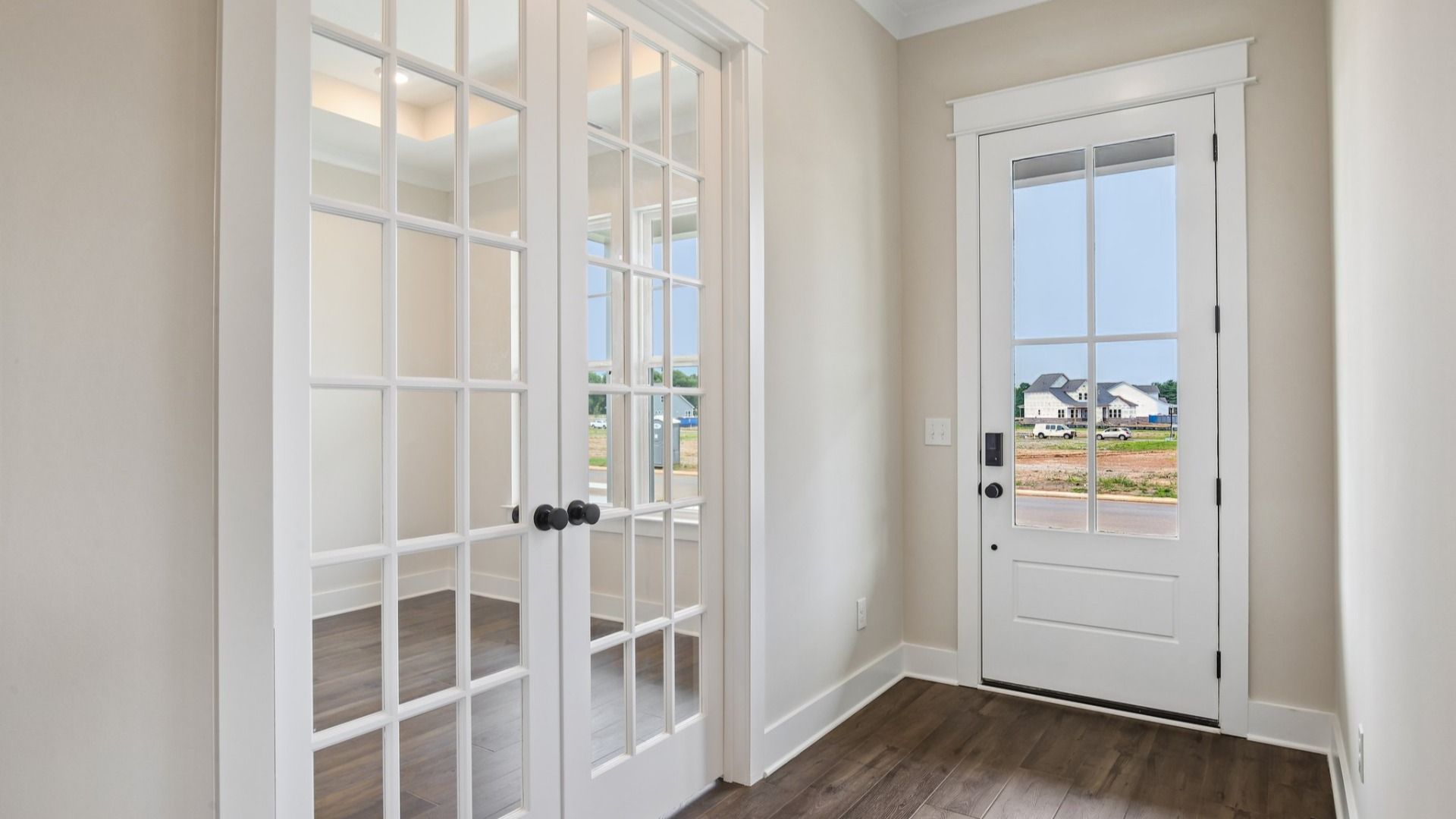 Interior front entry with access to study area with French doors