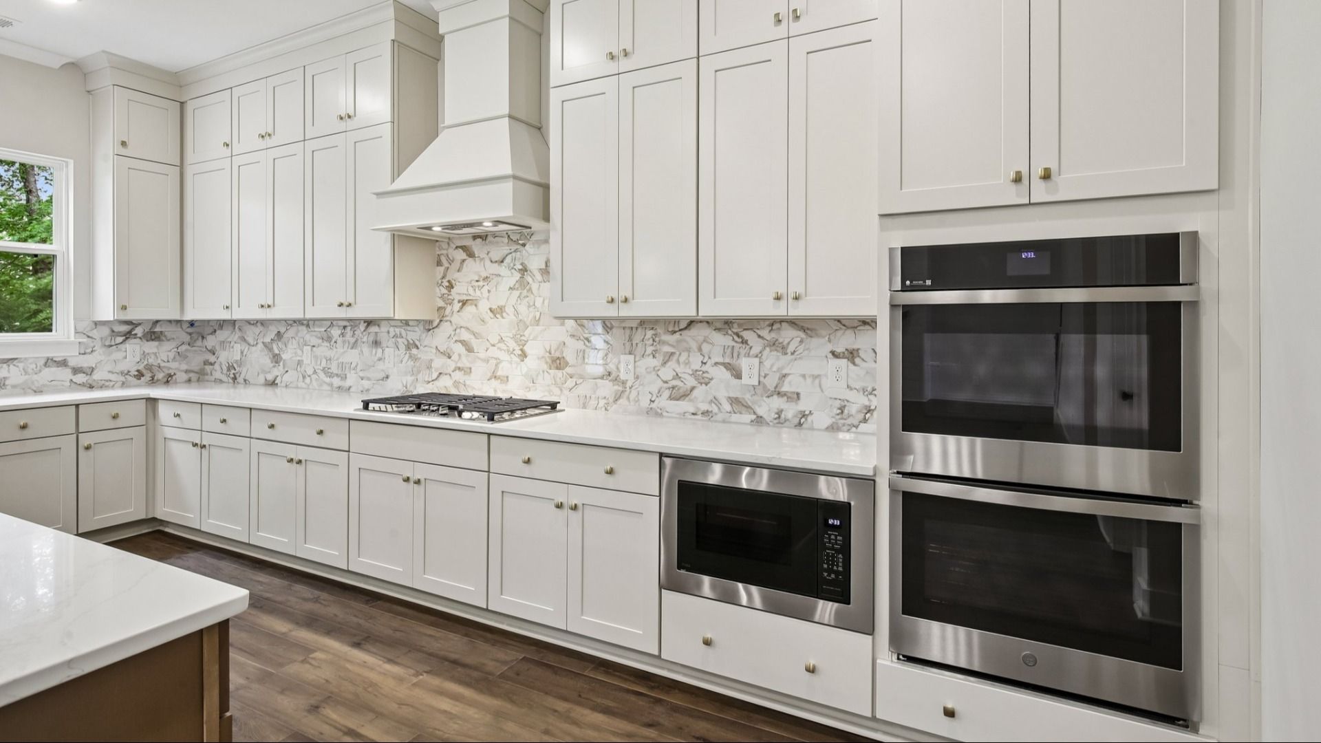 Kitchen with quartz countertops and tile backsplash