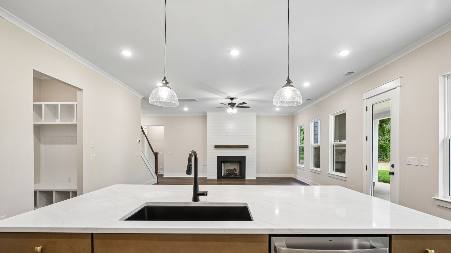 First floor with views of kitchen, spacious gathering room, and dedicated drop-zone