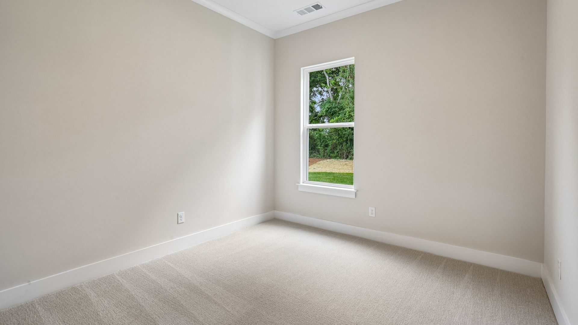 Bedroom with carpet and window