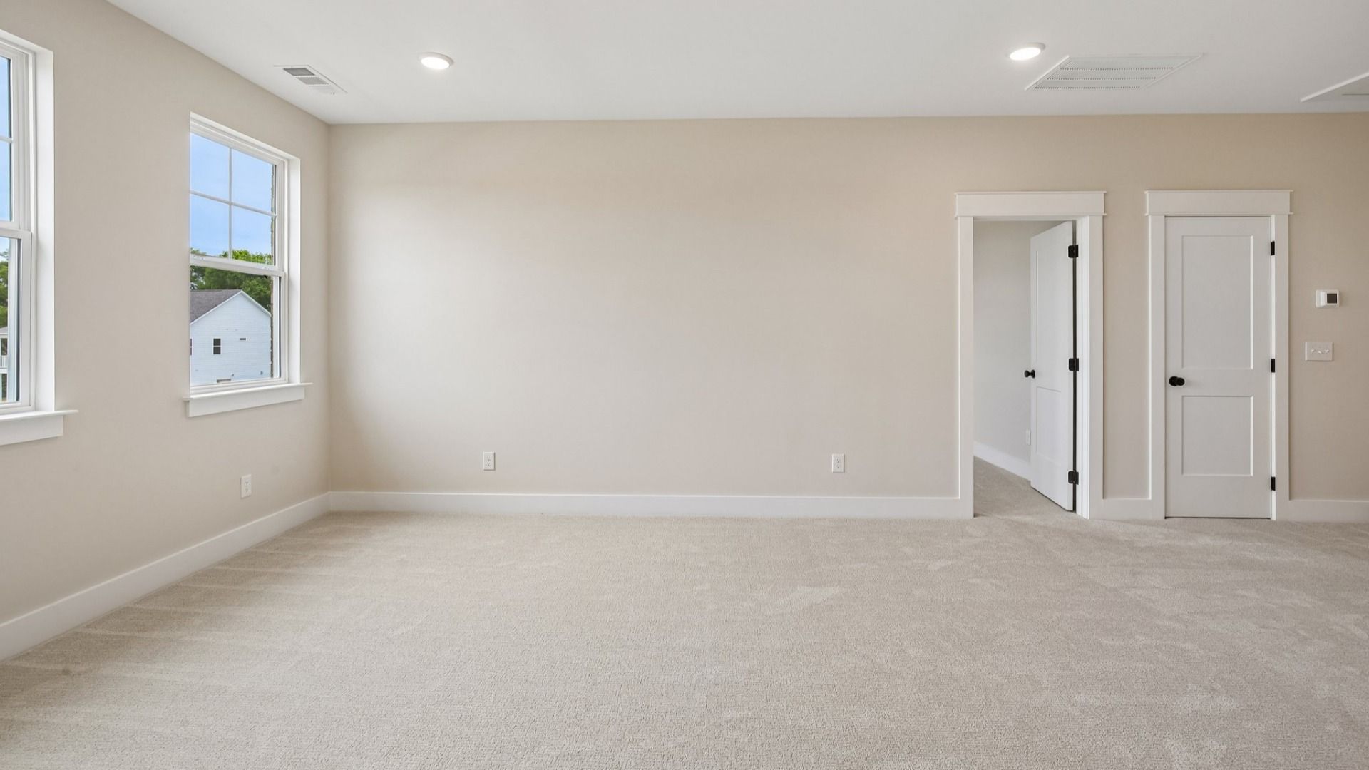 Loft area with carpet and windows